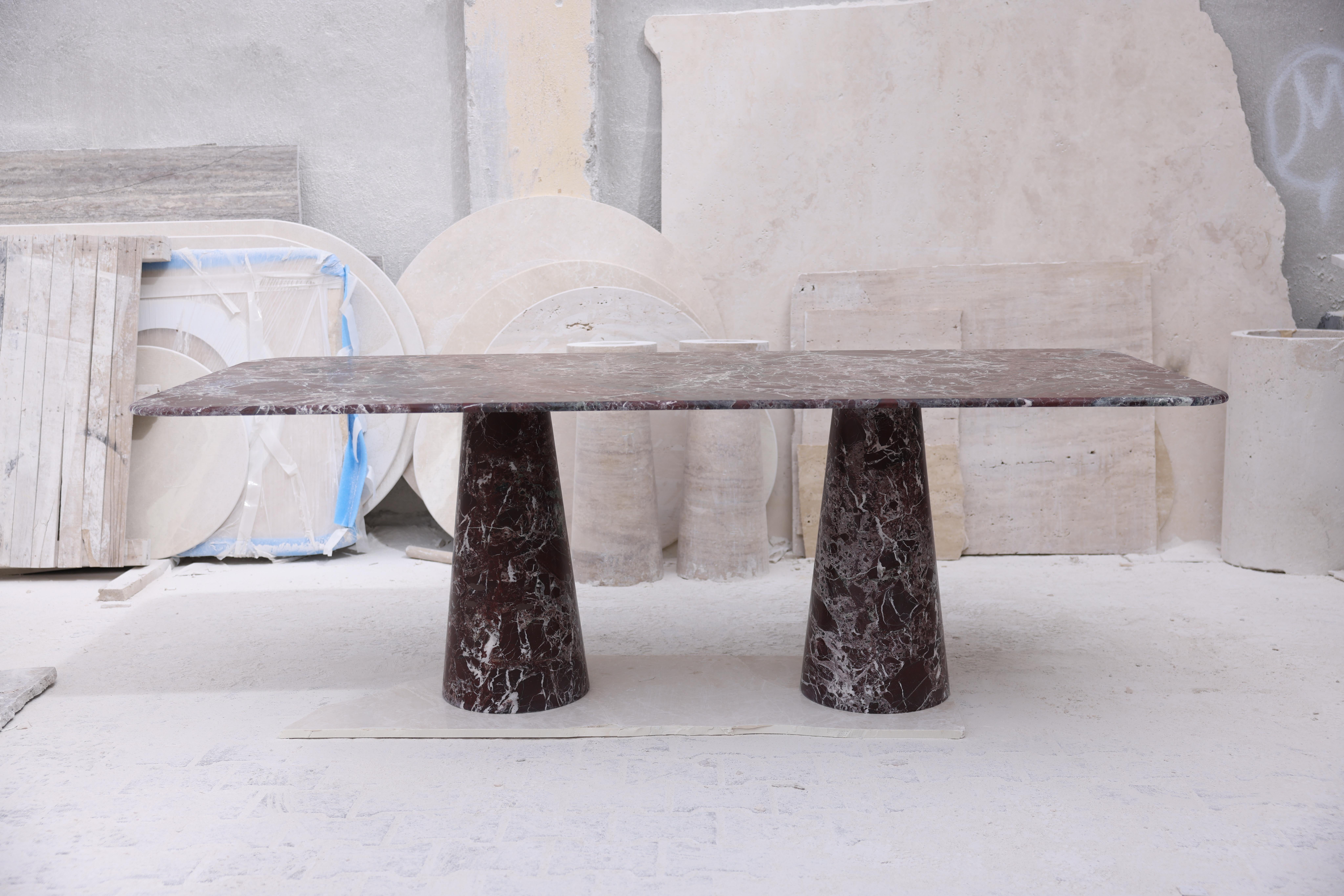This minimalist table is crafted from our stunning Red Rosso marble, featuring a softly curved rectangular top that balances perfectly and securely on two sculptural pedestal legs.

Inspired by the vintage designs of Angelo Mangiarotti, the column