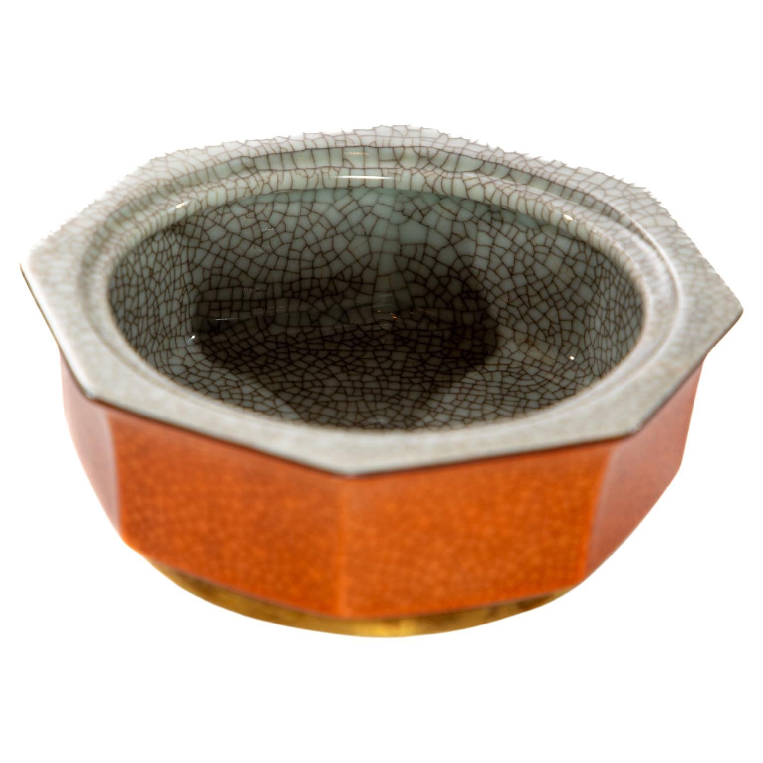 Small octagonal dish by Royal Copenhagen.  Red faux shagreen finish with gilt trim at base.  Circa 1925
No lid