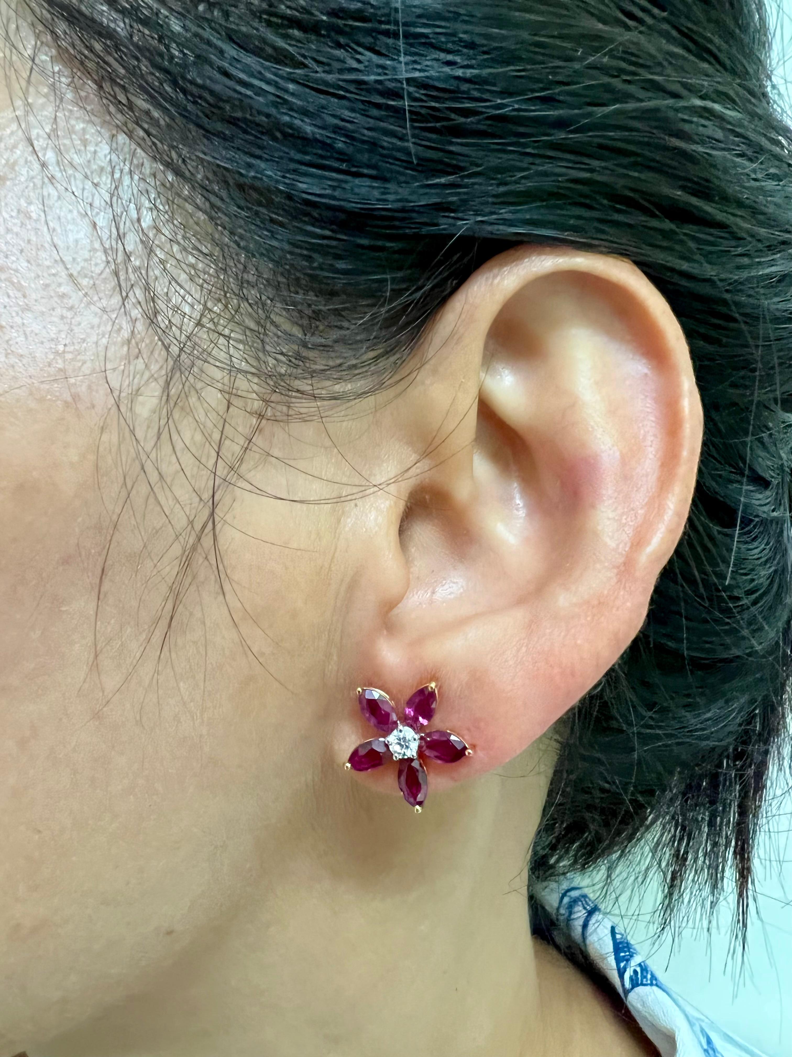 Please check out the HD video! These earrings GLOW! Here is a fantastic pair of bright red Ruby and diamond stud earrings. This flower earrings are absolutely beautiful and simple. The earrings are set in 18k Yellow gold. There are 10 marquise