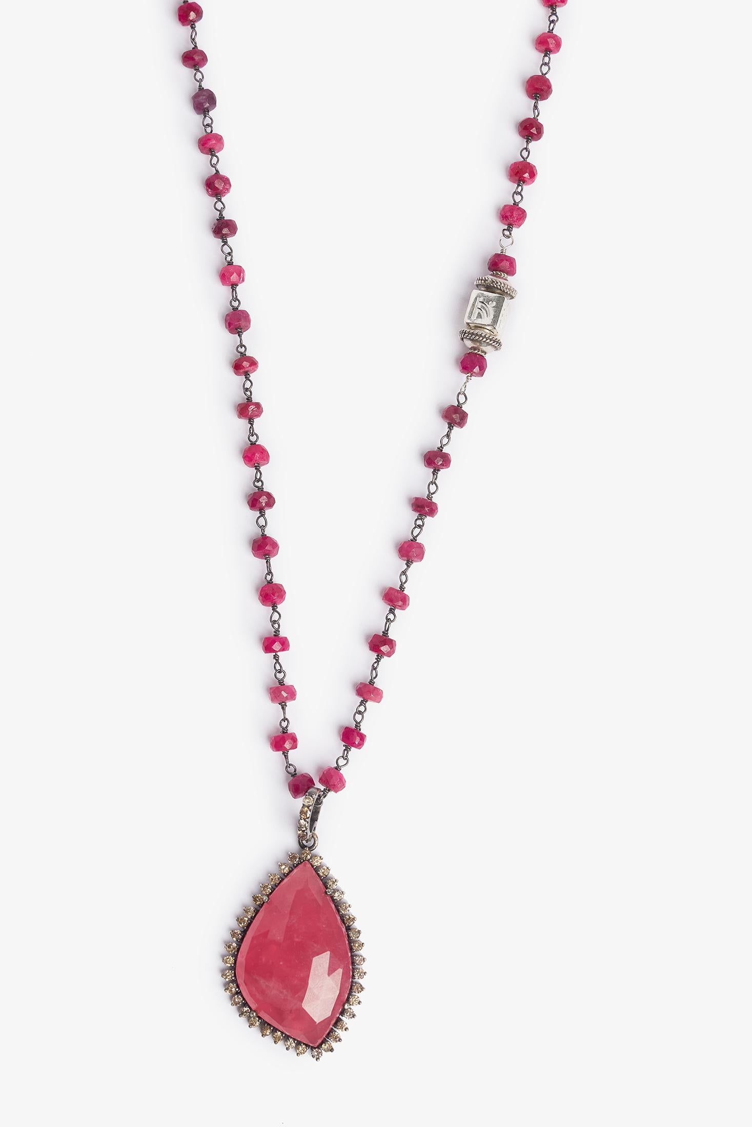 Story Behind the Jewelry
Ruby sterling silver chain accented with a rhodochrosite pave diamond pendant.  Rhodochrosite is the beautiful stone in the pave diamond pendant.  It is a stone that represents love and compassion.  The chain is adorned with
