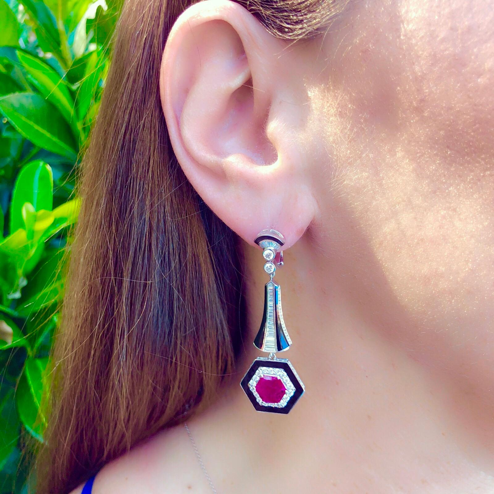 This striking pair of earrings by Italian designer Salavetti are a unique find! The 18k white gold drop earrings feature two hexagonal cut vibrant red rubies, together weighing 2.96 carats, then set front, side and reverse with 250 round brilliant