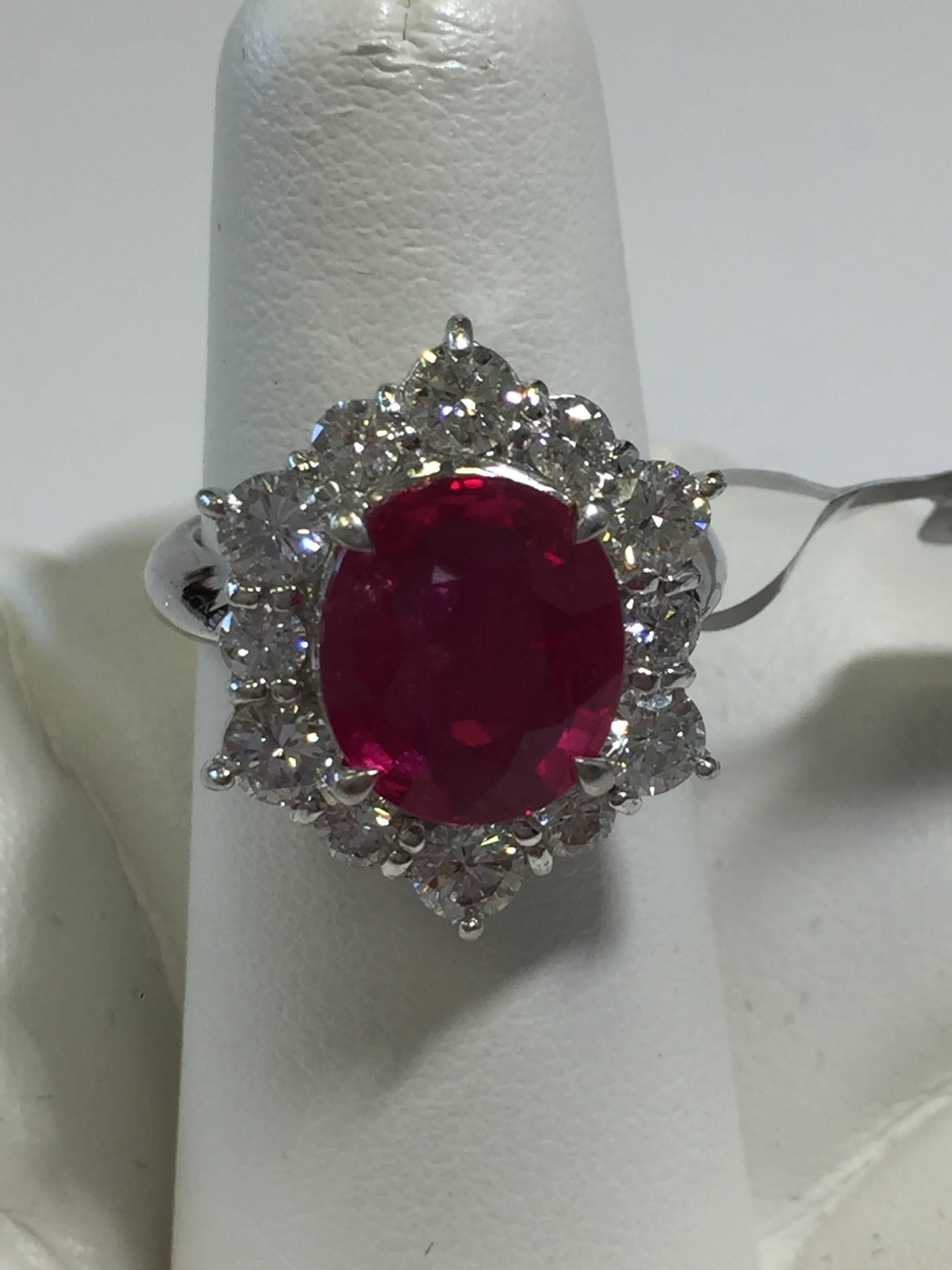 Breathtaking 5.01 carat red ruby oval with white diamond rounds in platinum.  A perfect addition to any collection and a great conversation piece! Size 5.75