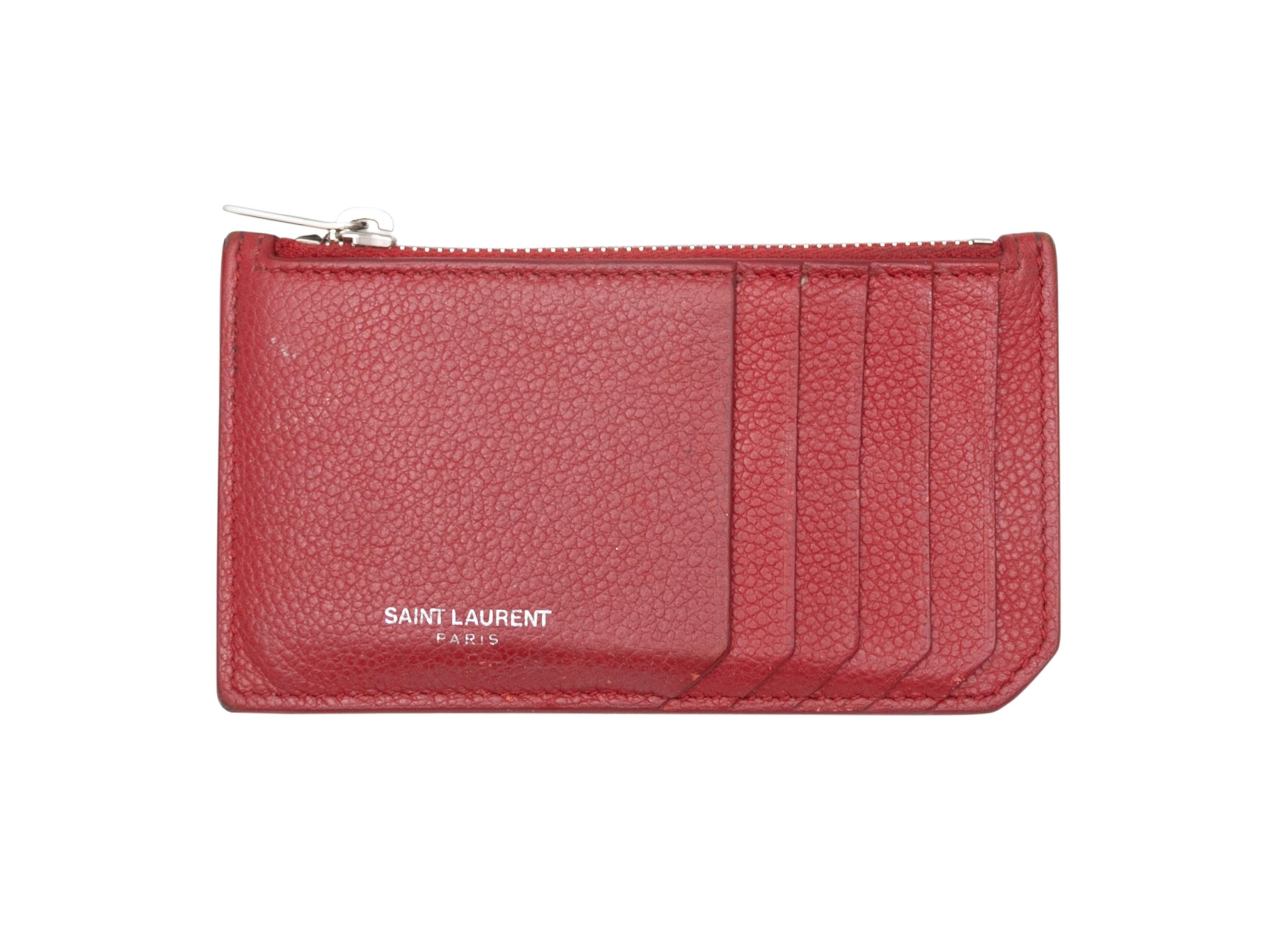 Red leather card holder wallet by Saint Laurent. Card and cash slots. Zip closure at top. 3
