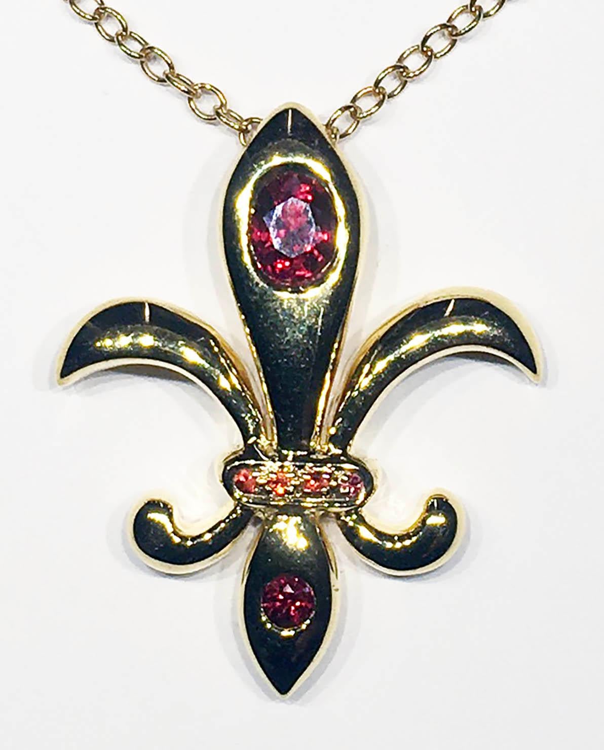 A 14kt Yellow Gold Fleur De Lis Pendant with 6 Red Sapphires.
These Sapphires have been heat treated in Chanthaburi Thailand with Beryllium to achieve this vivid Red color. Originally the Sapphires were mined in East Africa and were a yellowish