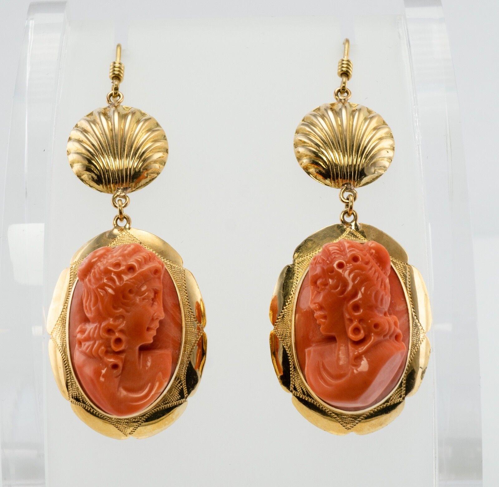 This gorgeous pair of earrings is finely crafted in solid 18K Yellow gold, they also have Italian marks. The genuine Coral high profile cameos measure 22mm x 15mm. They are highly detailed and very well made. The bottom dangling part of each earring