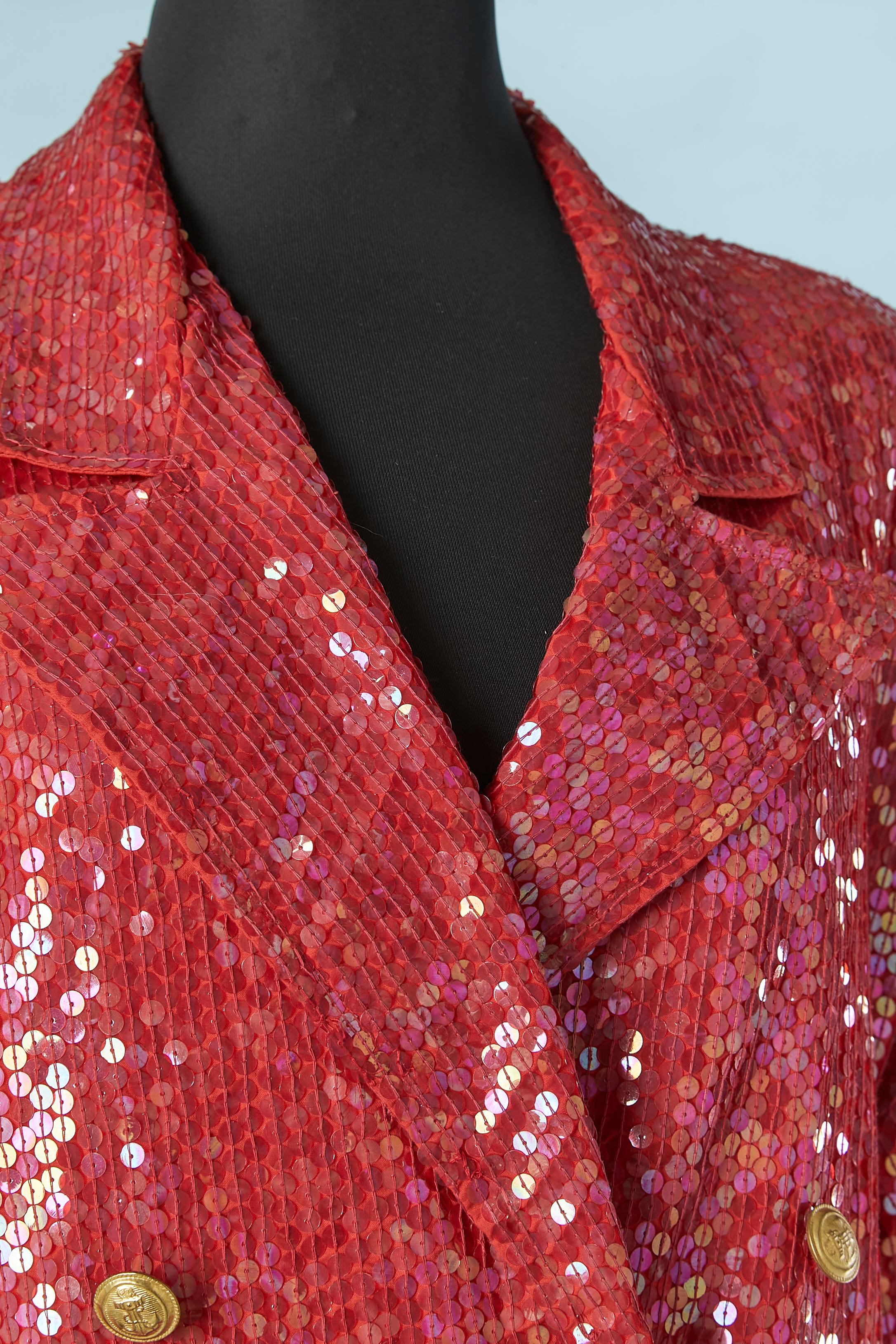 Red sequin double-breasted jacket with military buttons and gold braids.
Shoulder-pad. Button and buttonhole closure on the middle front. Pocket on both side. 
SIZE L 