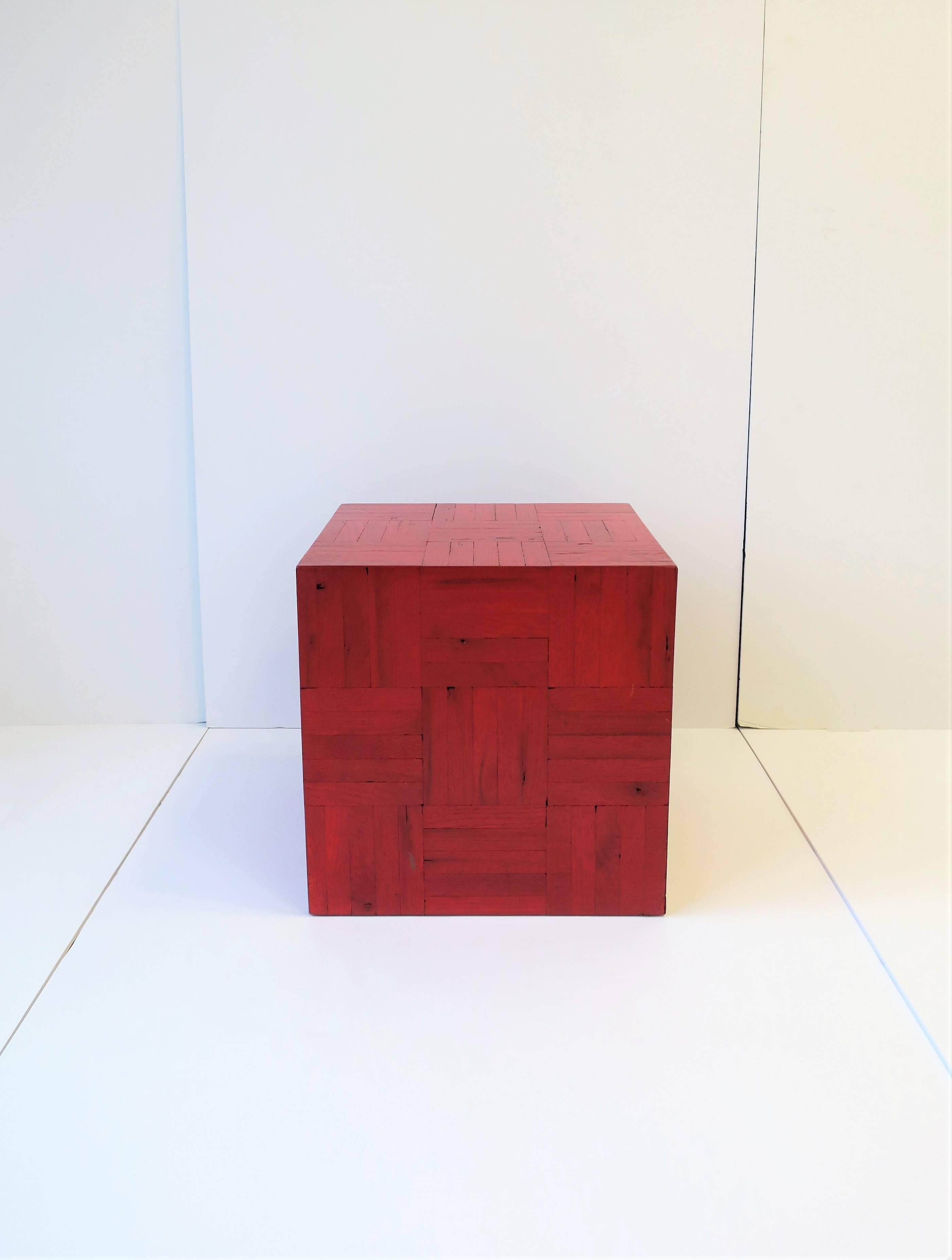 A square red side, drinks, or end table. 

Piece measures: 14