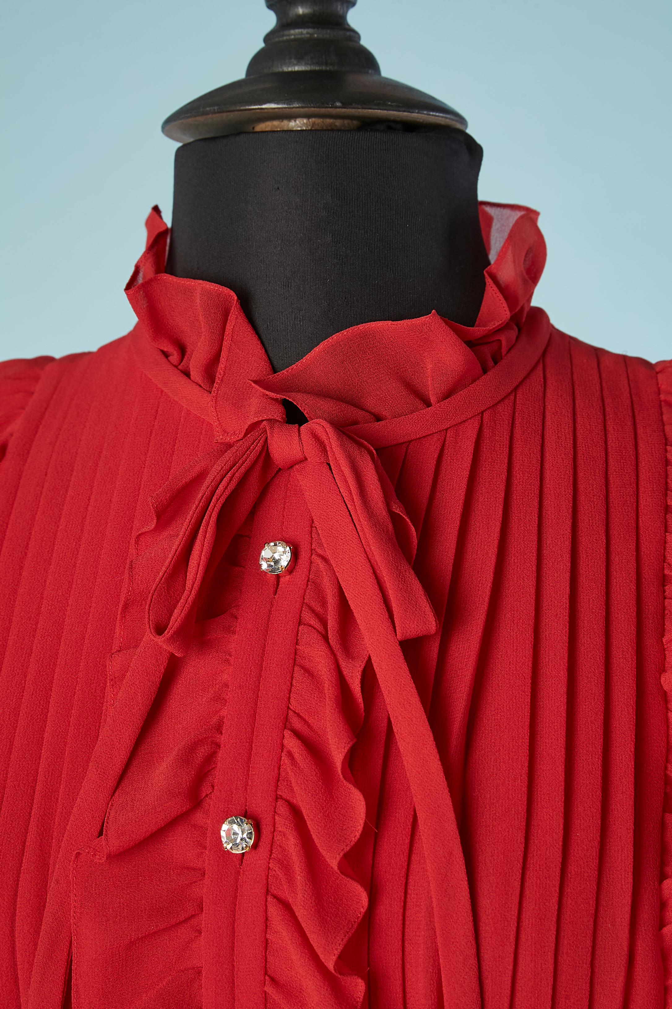 Red silk chiffon pleated cocktail dress with ruffles. Rhinestone buttons and bow on the collar. 
SIZE 38
Venet was born in Lyon, France. After training at the École Professionnelle des Tailors de Lyon he apprenticed at age 14 with 