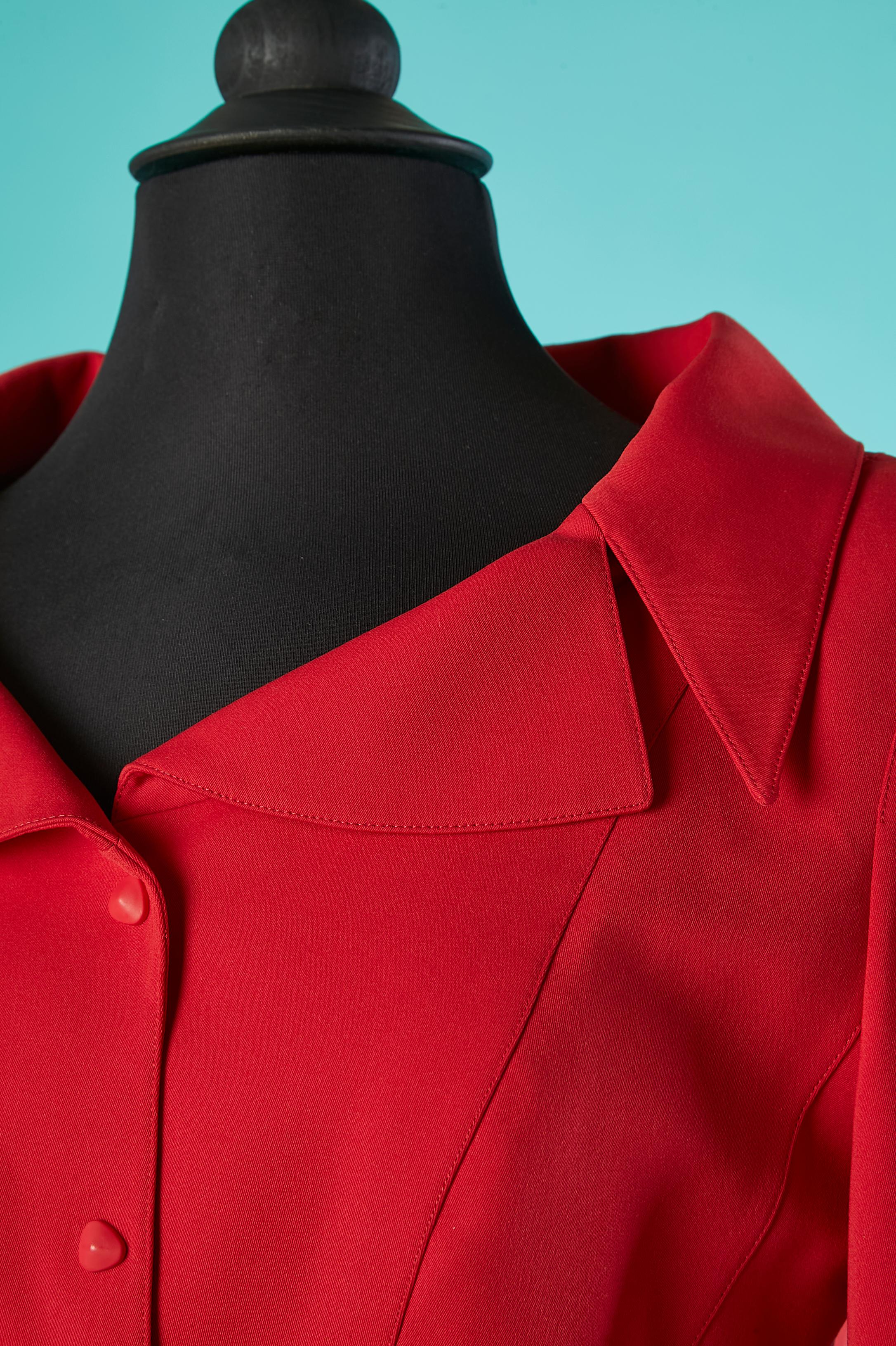 Red polyester skirt suit with gros-grain bow on the pockets. No fabric tag composition for the lining but probably acetate or rayon. 
Shoulder pad. Cut-work. Snap closure in the middle front. 
SIZE 38 (Fr) 6 (Us) 