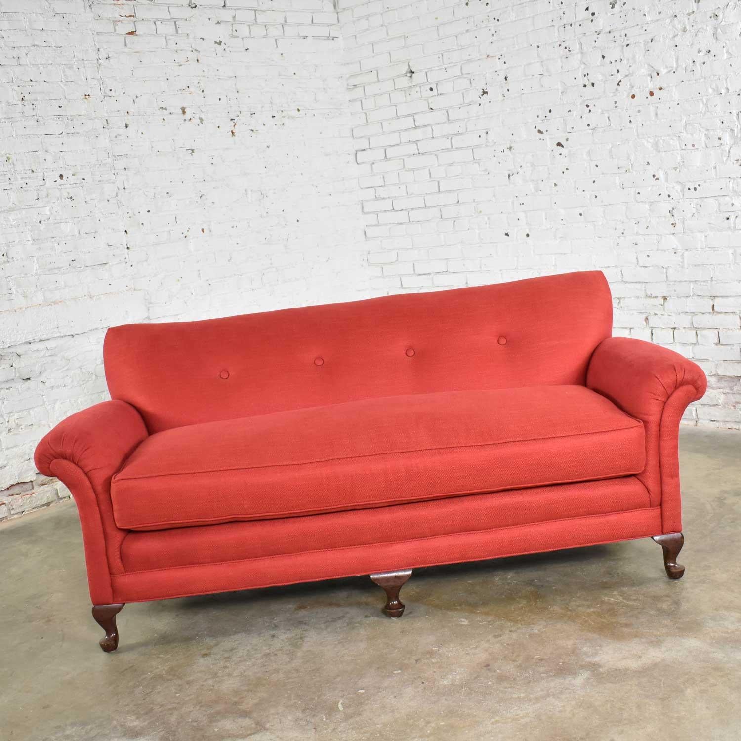 Incredible cranberry red sofa in a smaller size Lawson style with rolled arms, a down wrapped bench style seat, and a tight back with button detail. This is a vintage sofa that has been completely reworked and reupholstered and is in fabulous