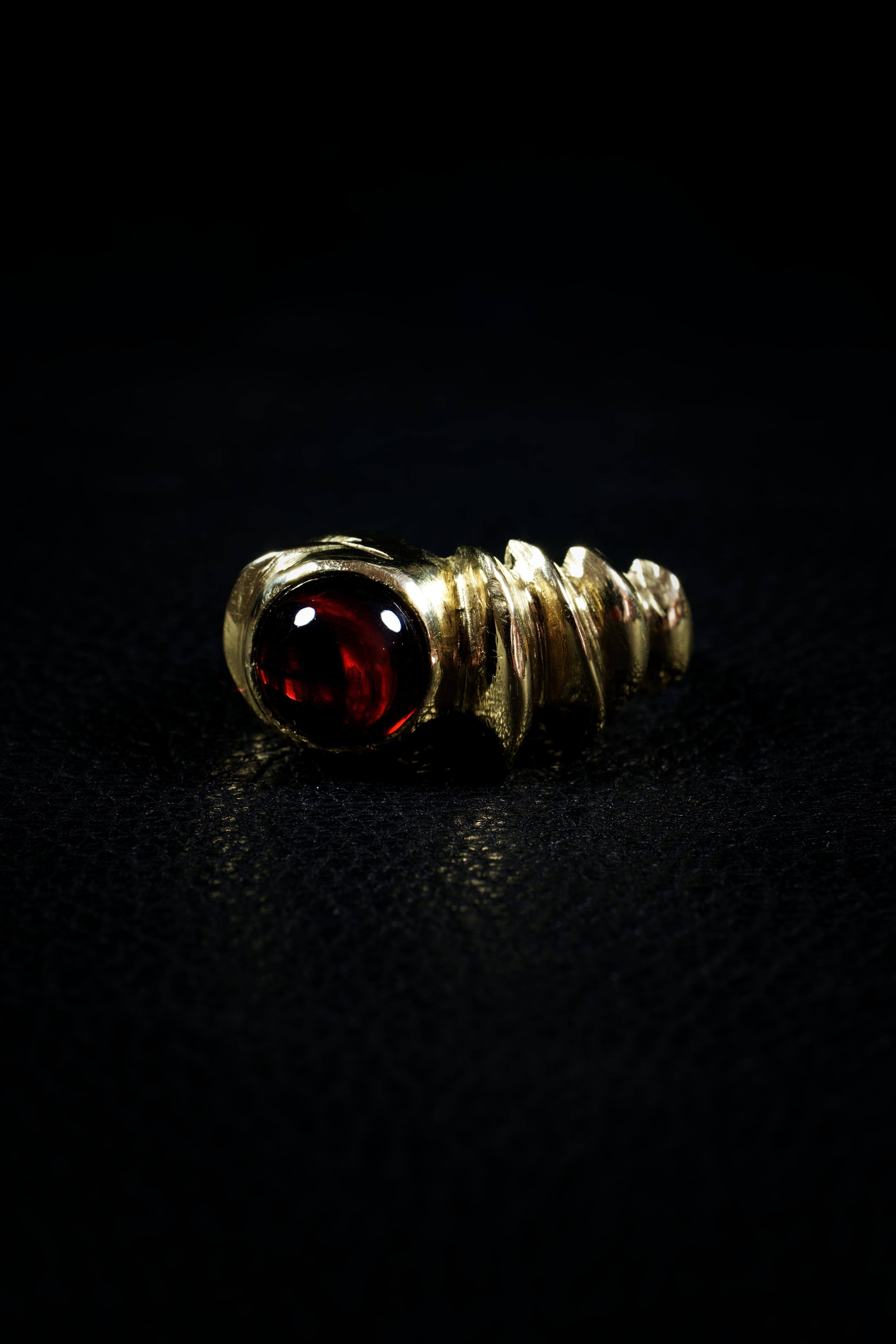 Red Sphere is a one-of-a-kind ring by Ken Fury that is hand-carved and cast in 10K solid yellow gold and features a genuine garnet stone. 

Stone: Genuine Garnet

Hand-signed.

Ring size: 9.5 
