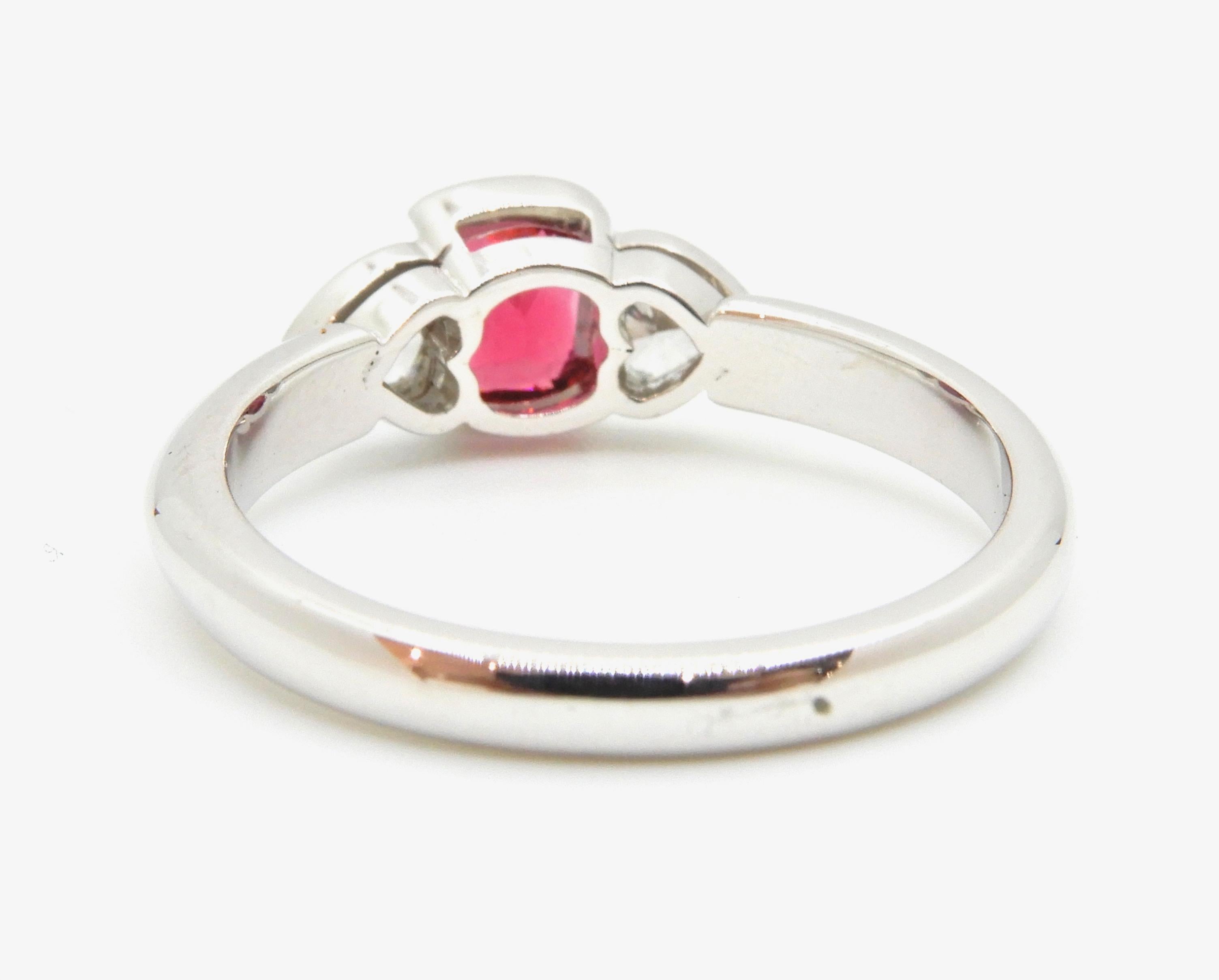 This amazing vivid coloured 0.89 carat faceted, cushion cut spinel red spinel takes centre stage in this Red Spinel and Heart Cut Diamond White Gold Handmade Three Stone Engagement Ring!

This sweet, handmade ring measures approximately 2.40mm and