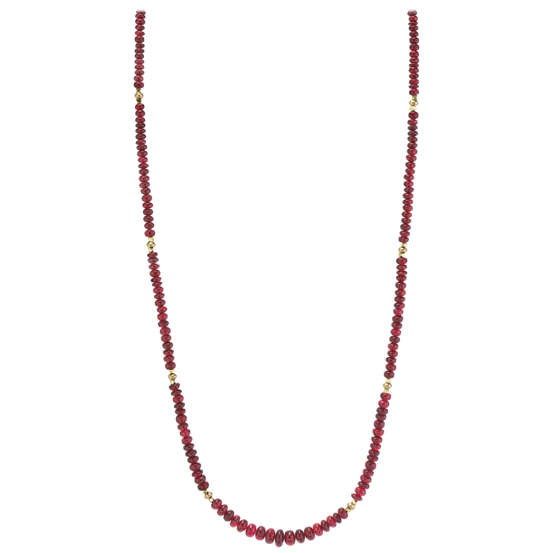 This strand of fine quality spinel beads would be at home in a 19th century ballroom or a 21st century boardroom! Rich, pomegranate red oval rondelles have been hand strung with 22k yellow gold spacers and an 18k yellow gold clasp in an elegant