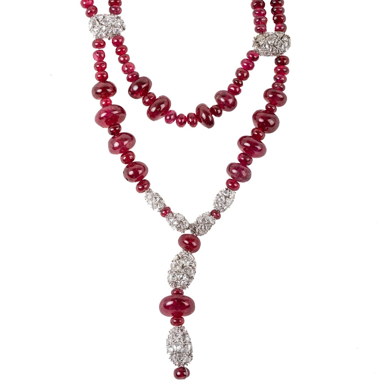 This necklace features deep red color spinel beads from Burma. 
Entwined in the necklace are diamond clusters set in white gold and a diamond clasp set in platinum.
Appx 250 carat spinel.