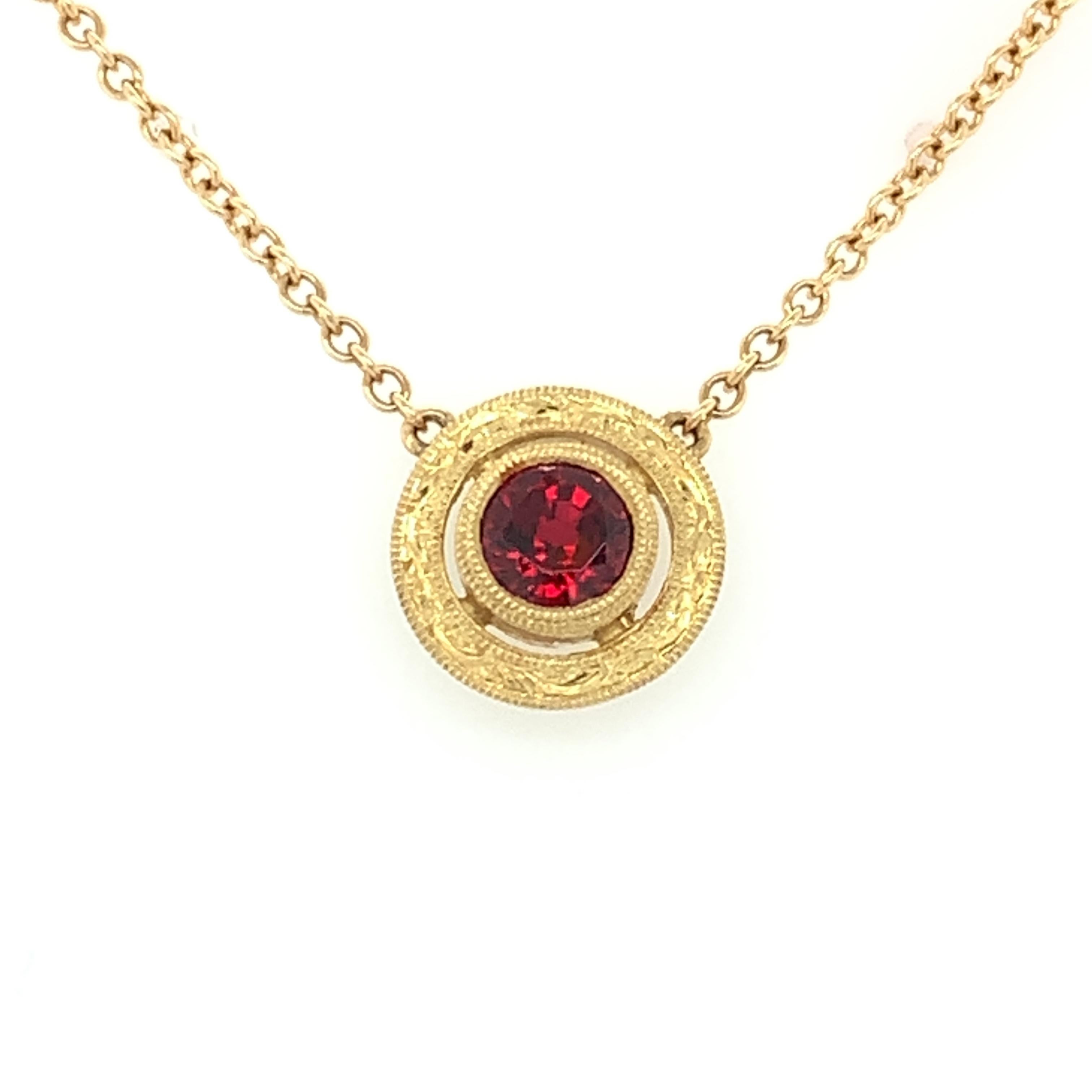 This pretty necklace features a brilliant, round, fiery red 