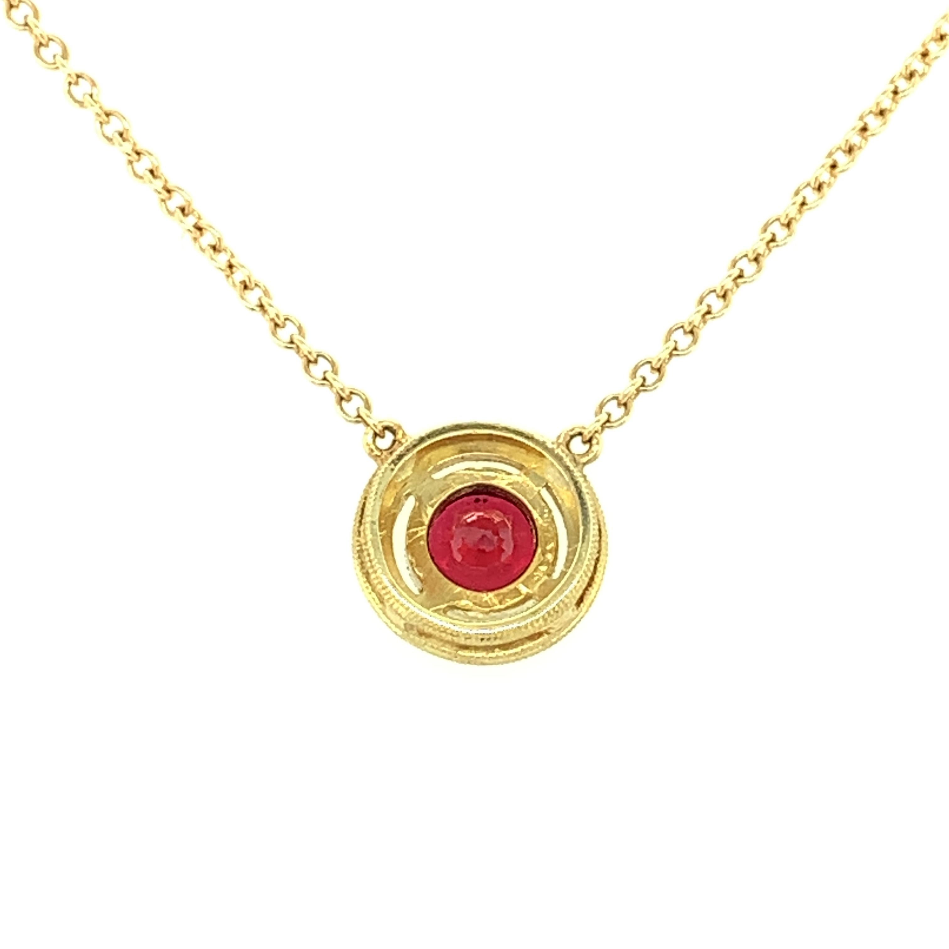 gold necklace with red pendant