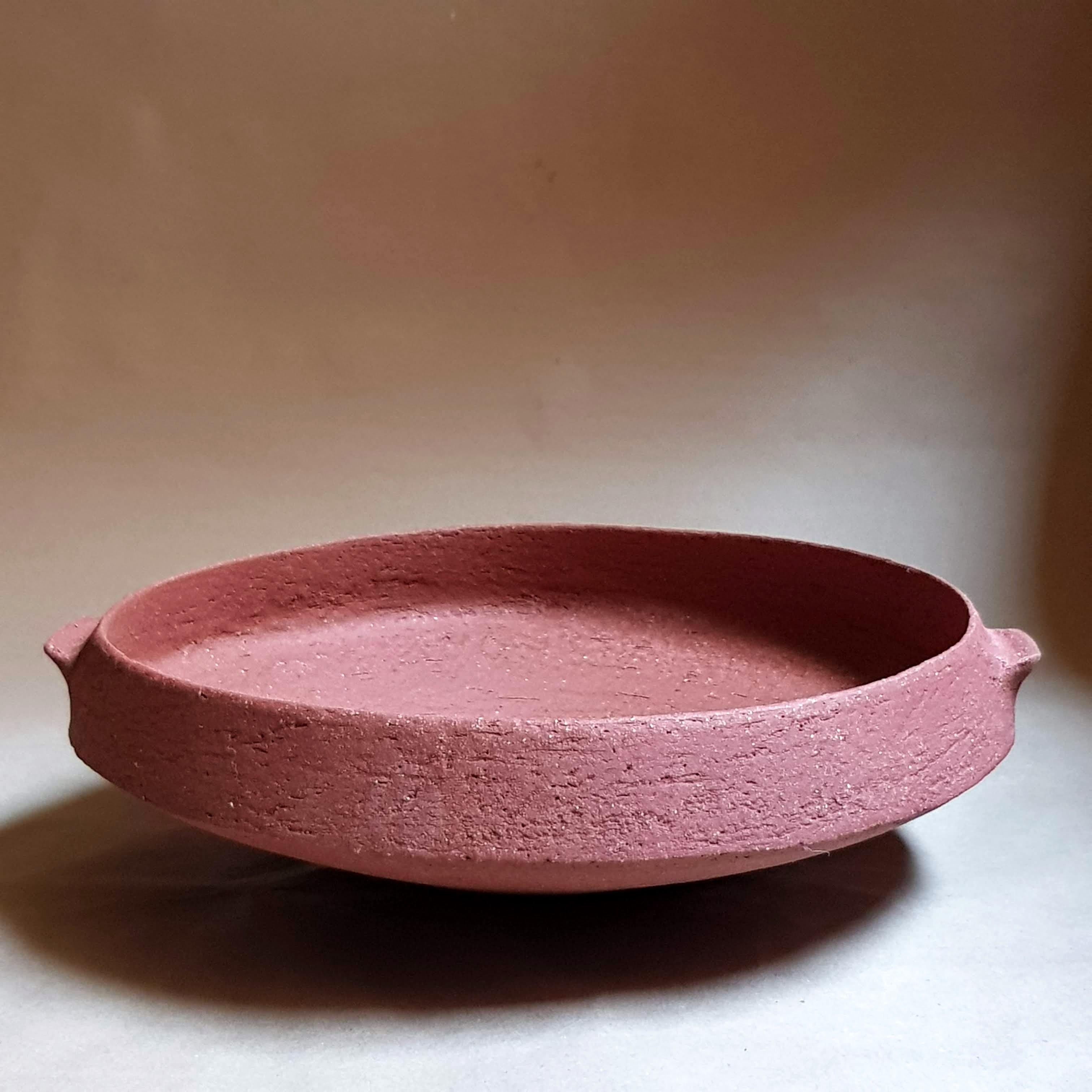 Red Stoneware Pinakio Plate with Handles by Elena Vasilantonaki
Unique
Dimensions: ⌀ 34 x H 10 cm (Dimensions may vary)
Materials: Stoneware
Available finishes: With\without handles - Black, White, Grey , Brown, Red, White Patina

Growing up in