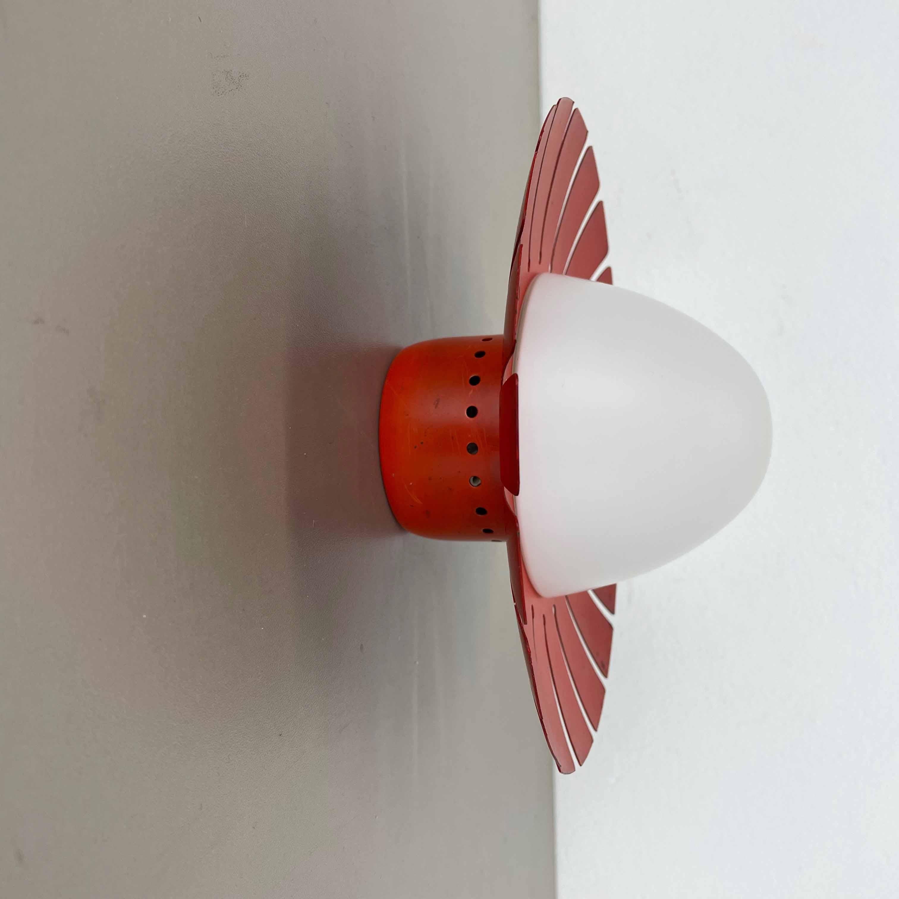 Article:

Wall light sconces with opal glass shade.



Origin:

Italy



Age:

1960s.



Original 1960s modernist Italian wall light made of solid metal in original red tone finish and opal glass element in the middle. The backside