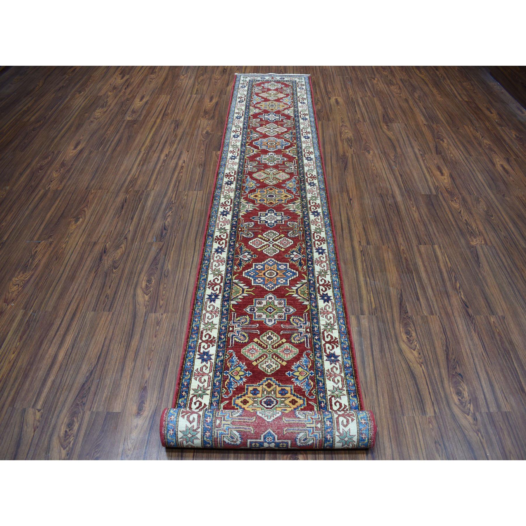 This is a truly genuine one-of-a-kind Red Super Kazak Geometric Design XL Runner Pure Wool Hand-Knotted Rug. It has been Knotted for months and months in the centuries-old Persian weaving craftsmanship techniques by expert artisans. 
Primary