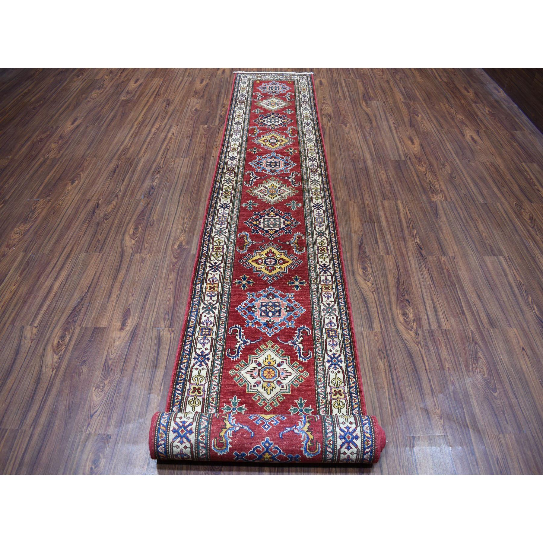 This is a truly genuine one-of-a-kind red super Kazak geometric design extra-large runner pure wool hand knotted Oriental rug. It has been knotted for months and months in the centuries-old Persian weaving craftsmanship techniques by expert