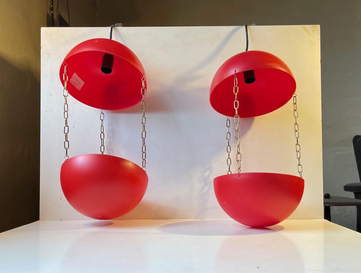 A pair of red plastic ceiling pendants with chain suspended planters suitable for a flower pot. These were manufactured and designed by E. S. Horn in Denmark during the 1960s or 70s. This set is NOS (new old stock) and has newer been installed/used.