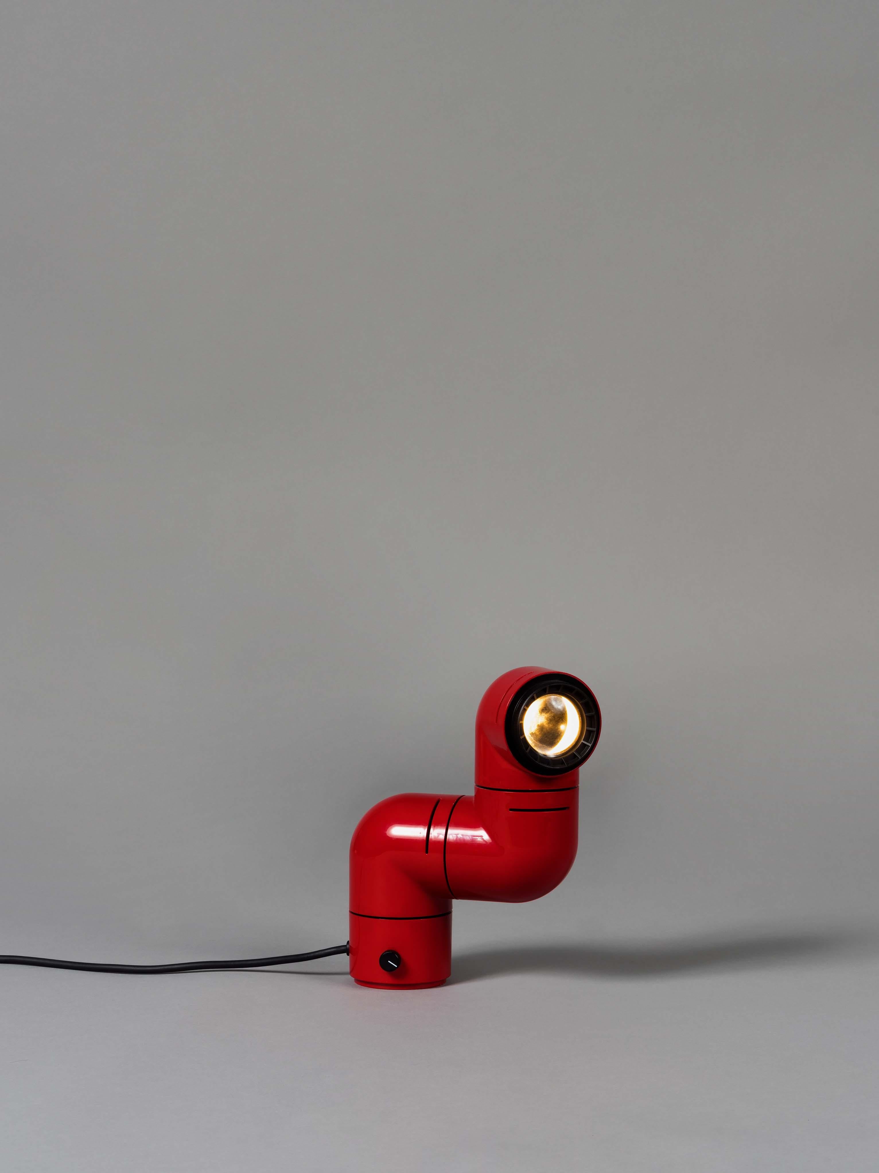 Red Tatu table/wall lamp by André Ricard
Dimensions: D 20.5 x W 8 x H 25 cm
Materials: ABS plastic.
Available in white or red.

Tatu is an object-lamp that has become memorable icon of Spanish pop culture of the 1970s. Incorporating LED