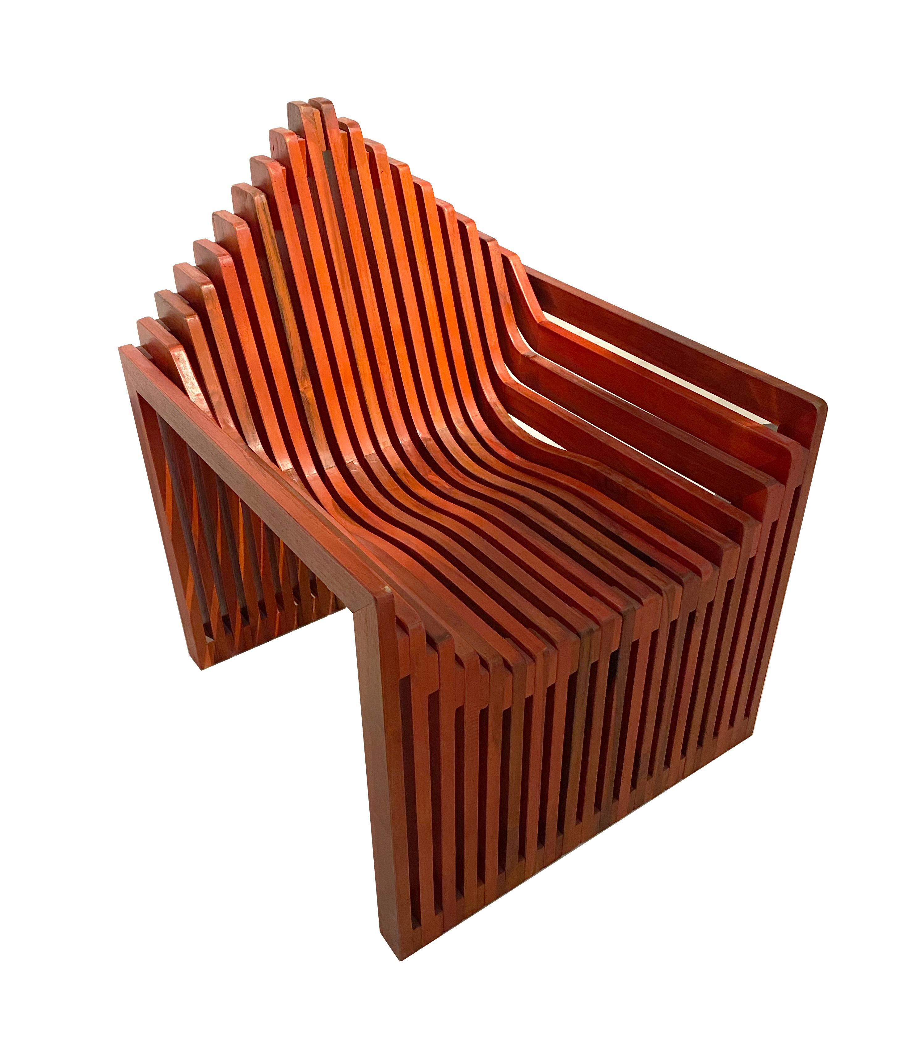 Handcrafted parametric chair made of solid teak wood. This stunning red-stained accent chair is part of the Fabri Collection by John Brevard. The Fabri collection features fabric-like weaving landscapes which unite to become one.  These pieces are