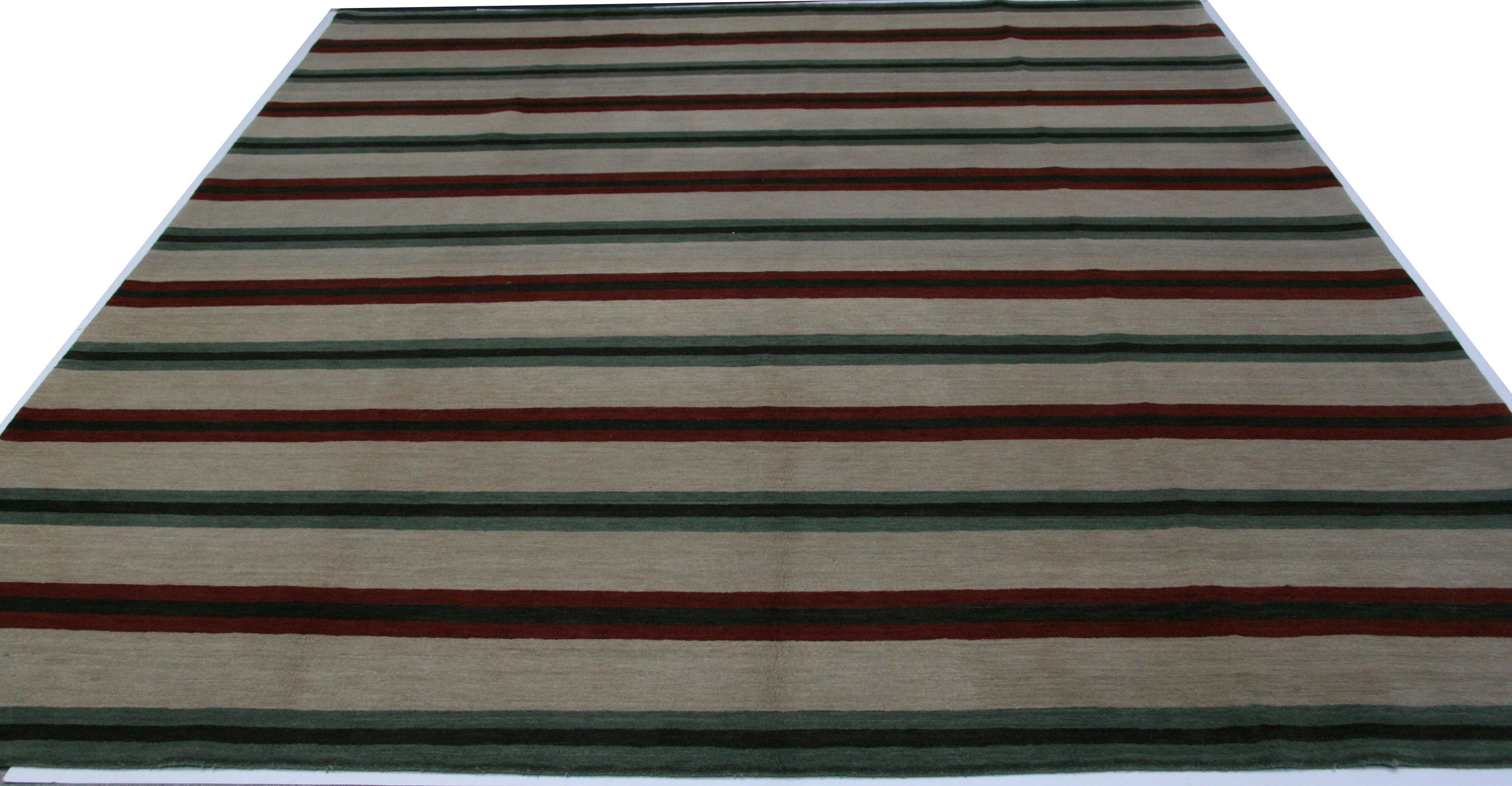 Simple stripes in red, teal, black and beige add up to a charming rug for the contemporary home or office. Hand knotted in Nepal using wool dyed with natural vegetal dyes.