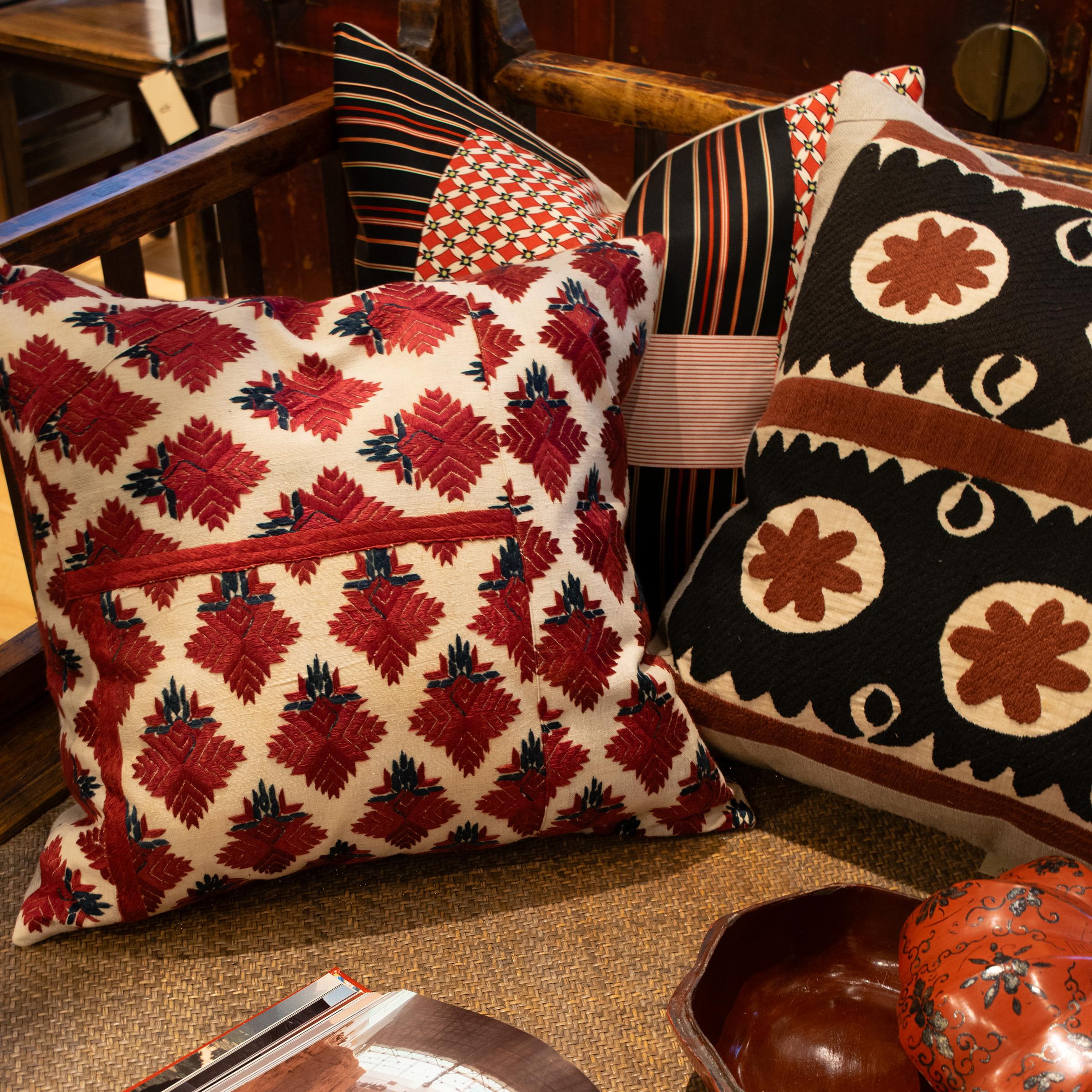 This pillow's creator starts from a place of traditional patterning. The artisan selects fine examples of Asian textiles to attach to linen backs and create down-filled works of art. By rearranging and re-stitching this traditional Indian textile,