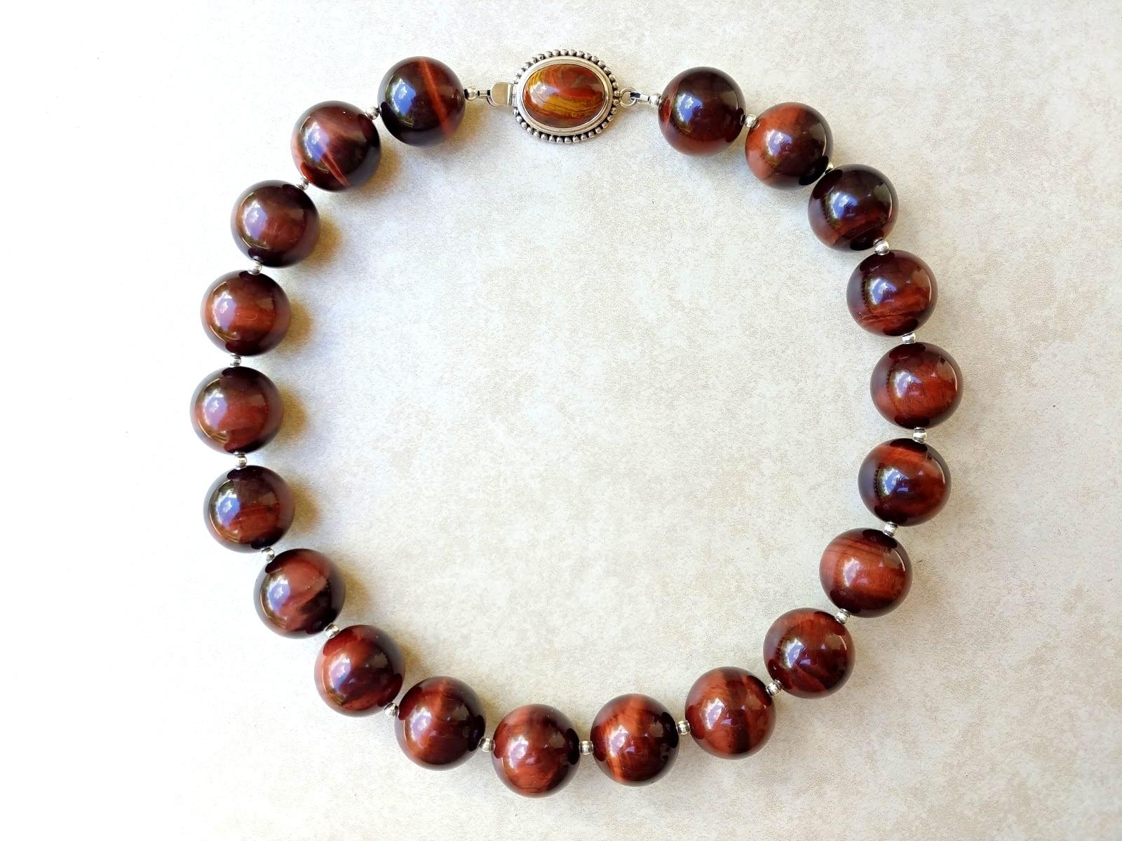 The length of the necklace is 18.5 inches (47 cm). The size of the smooth round beads is 20 mm. The beads are very high quality.
The tones of the beads are a wondrous silky chocolate-red, luxurious — gorgeous, warm shade of autumn.
The tiger eye was