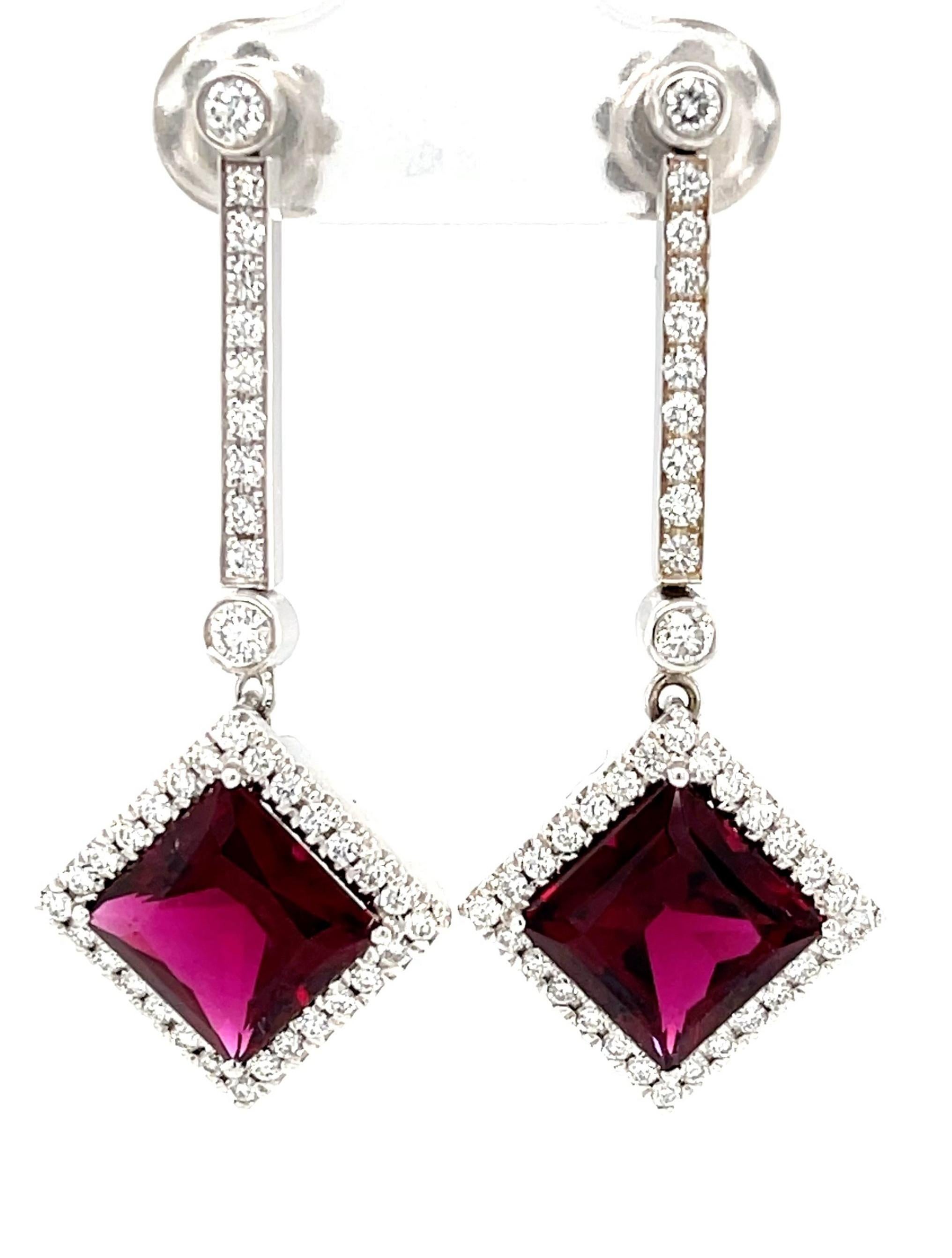 Striking pomegranate colored tourmaline and diamond earrings are bold, beautiful, and ready to make you the center of attention! Set in 18k white gold, these dramatic square cut red tourmalines are framed with brilliant cut diamonds, creating a