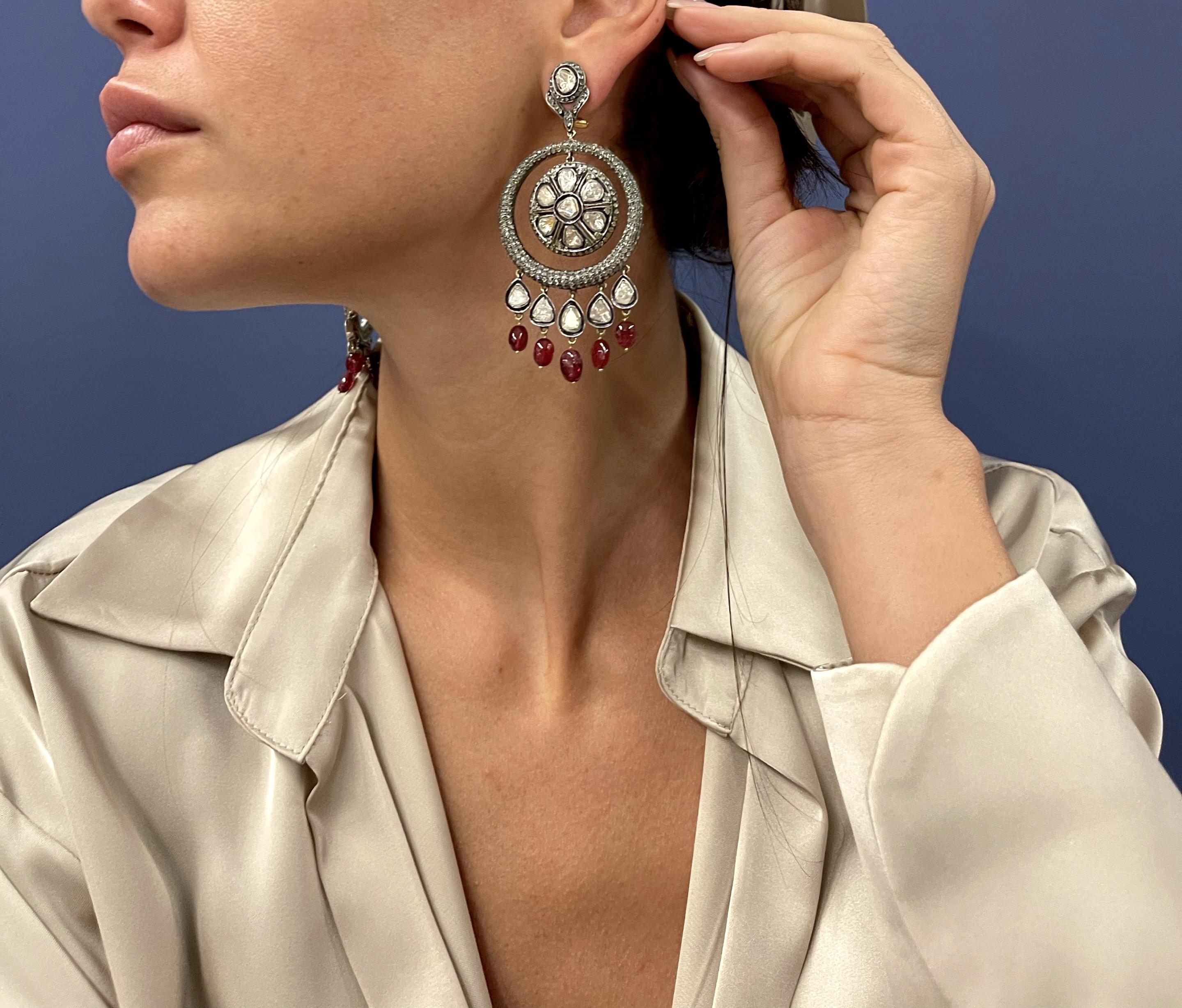 Brilliant, shining and stunning large chandelier earrings made in silver and gold, embellished by rose and diamond cut diamonds and  red oval drop tourmalines. 
These earrings are eye catching very brilliant, unique they will elegantly sway as you