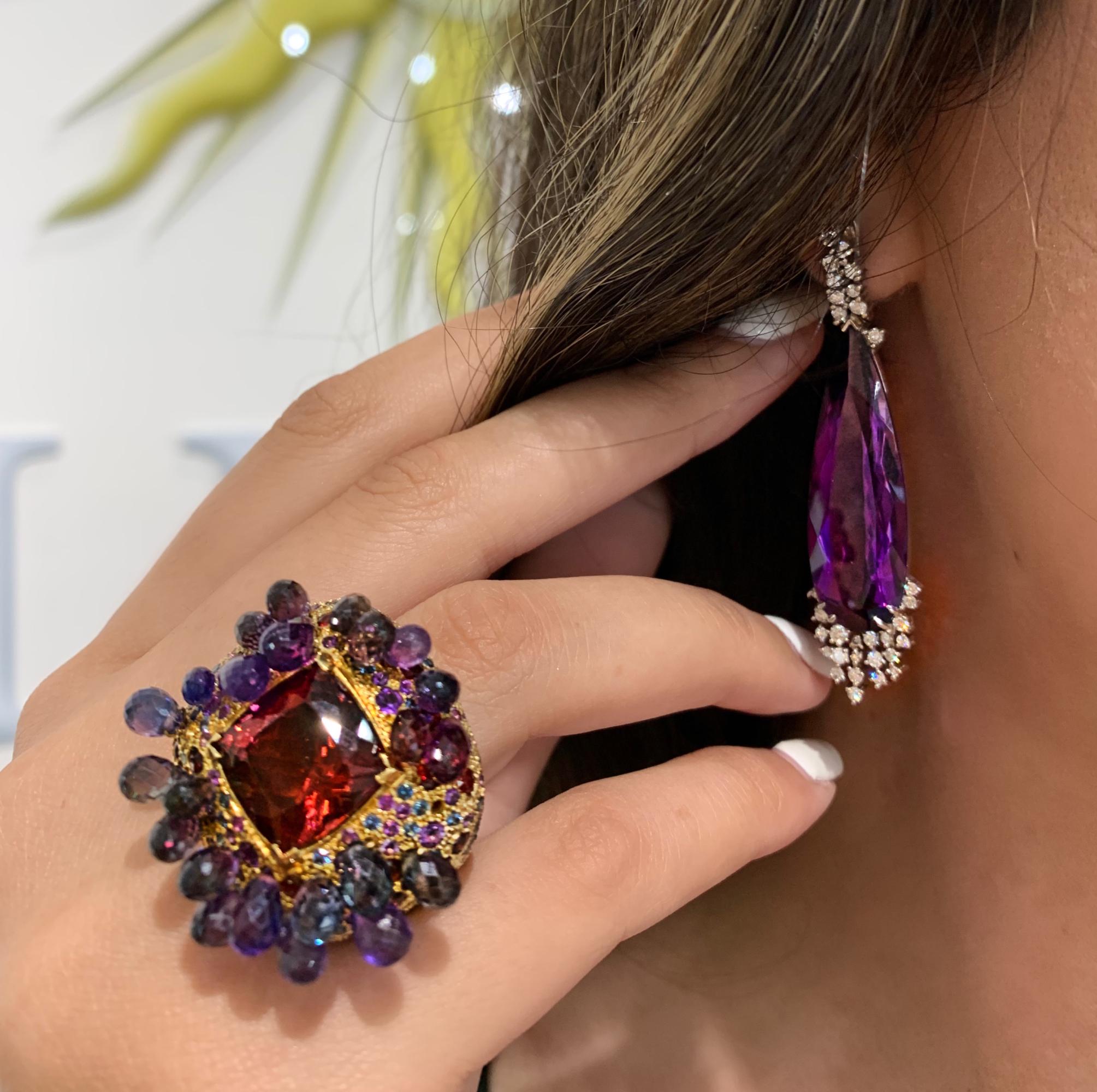 Specs: 18k yellow gold ring with 10.66 carats Wine Red Tourmaline, 29.29 carats Purple, Green and Blue Sapphire Briolette, .15 carats Amethyst, .39 carats Garnet, .64 carats Blue and Purple Sapphire, and .44 carats Tsavorite. Legend has it that