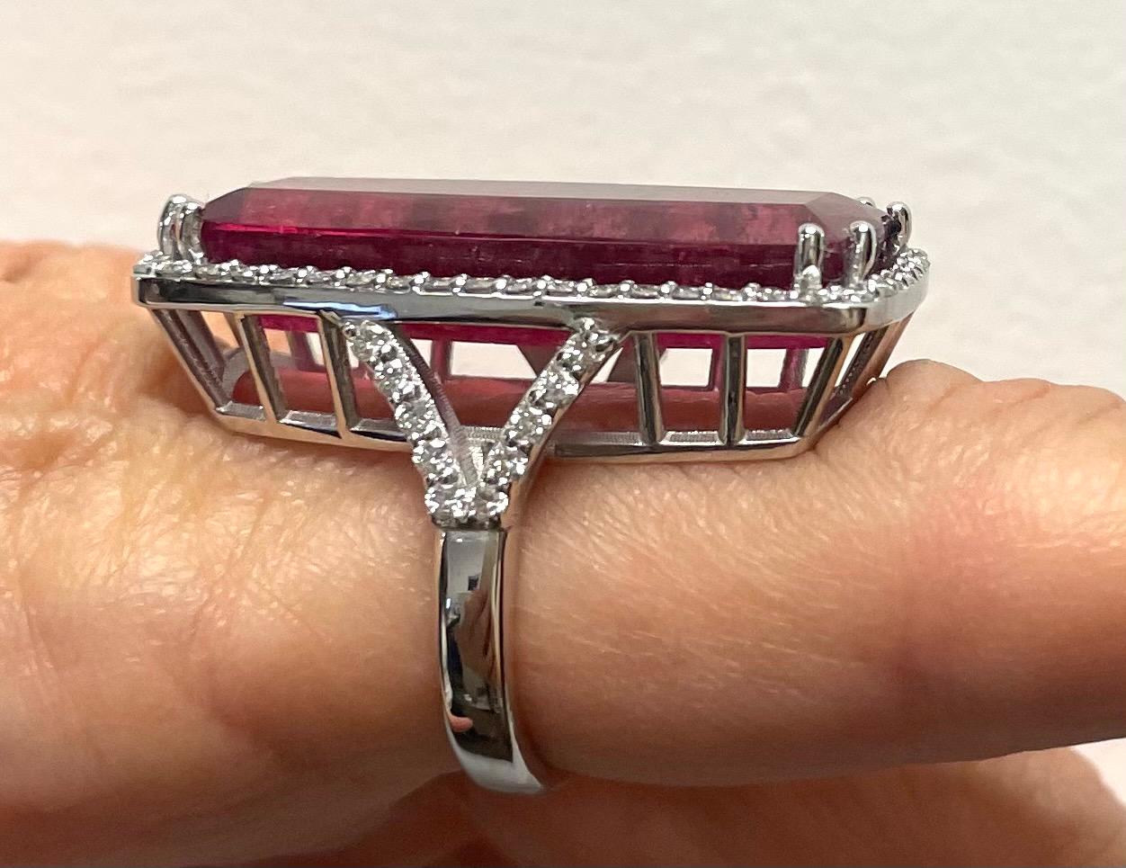 Description
This striking 25.5 carat elongated emerald cut Red Tourmaline ring is embellished with 1.32 carats pave diamonds, and is set in a 14k white gold Y-shape band. 
Item #R180

Materials and Weight
Red Tourmaline 25.5 cts 31.2x13.8x7.1mm,