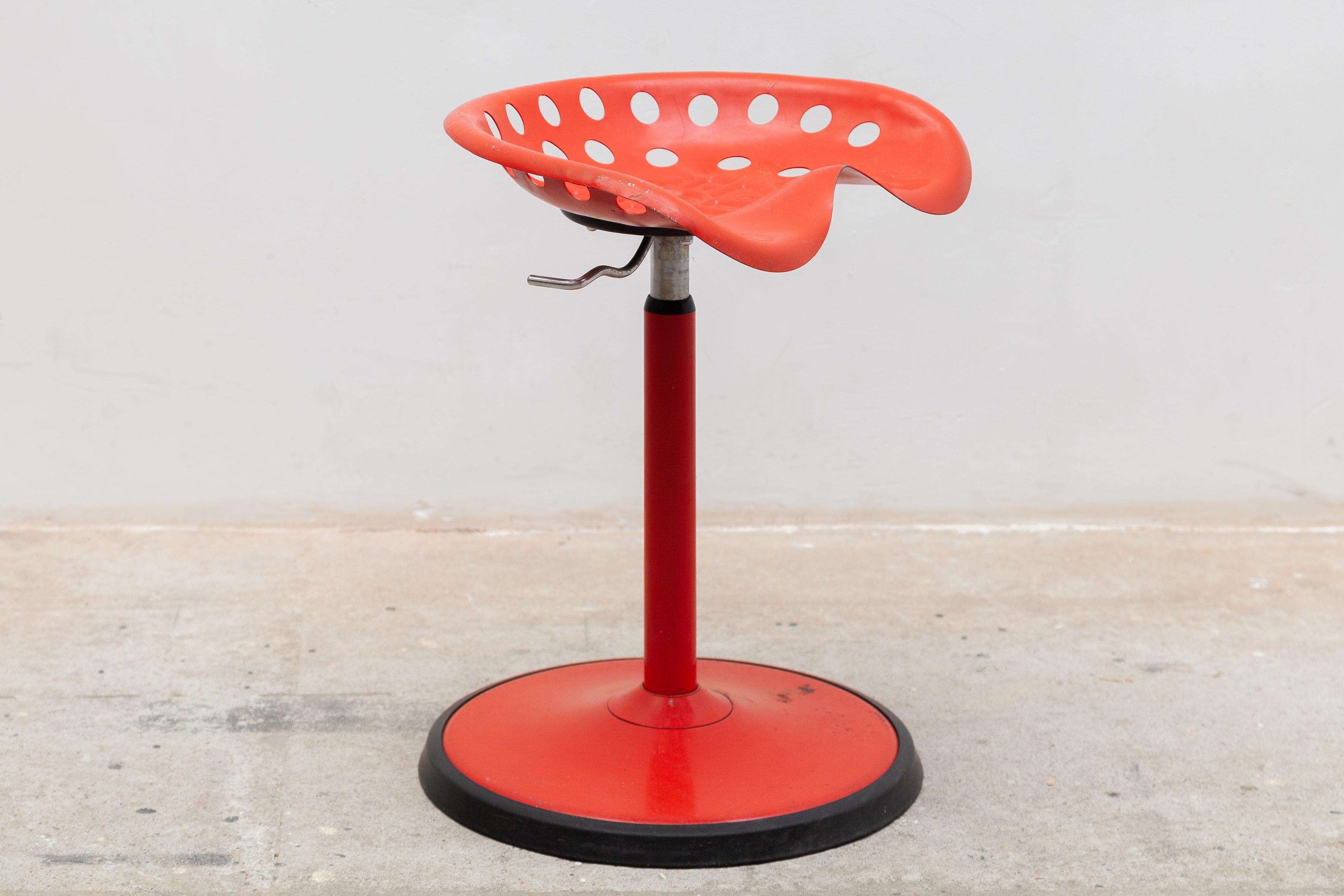 Beautiful red adjustable stool designed by Etienne Fermigier for Mirima in the 70s.The stool is adjustable in height maximum height is 70cm and has an iron red lacquered base with rubber. The stool is in good condition signs of wear appropriate to