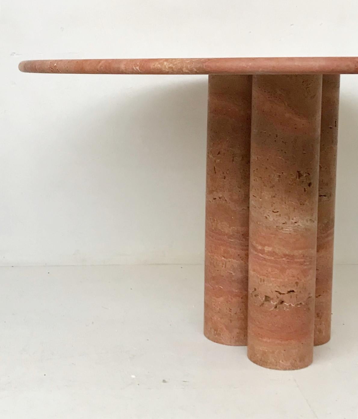 Red travertine dining table by Mario Bellini.