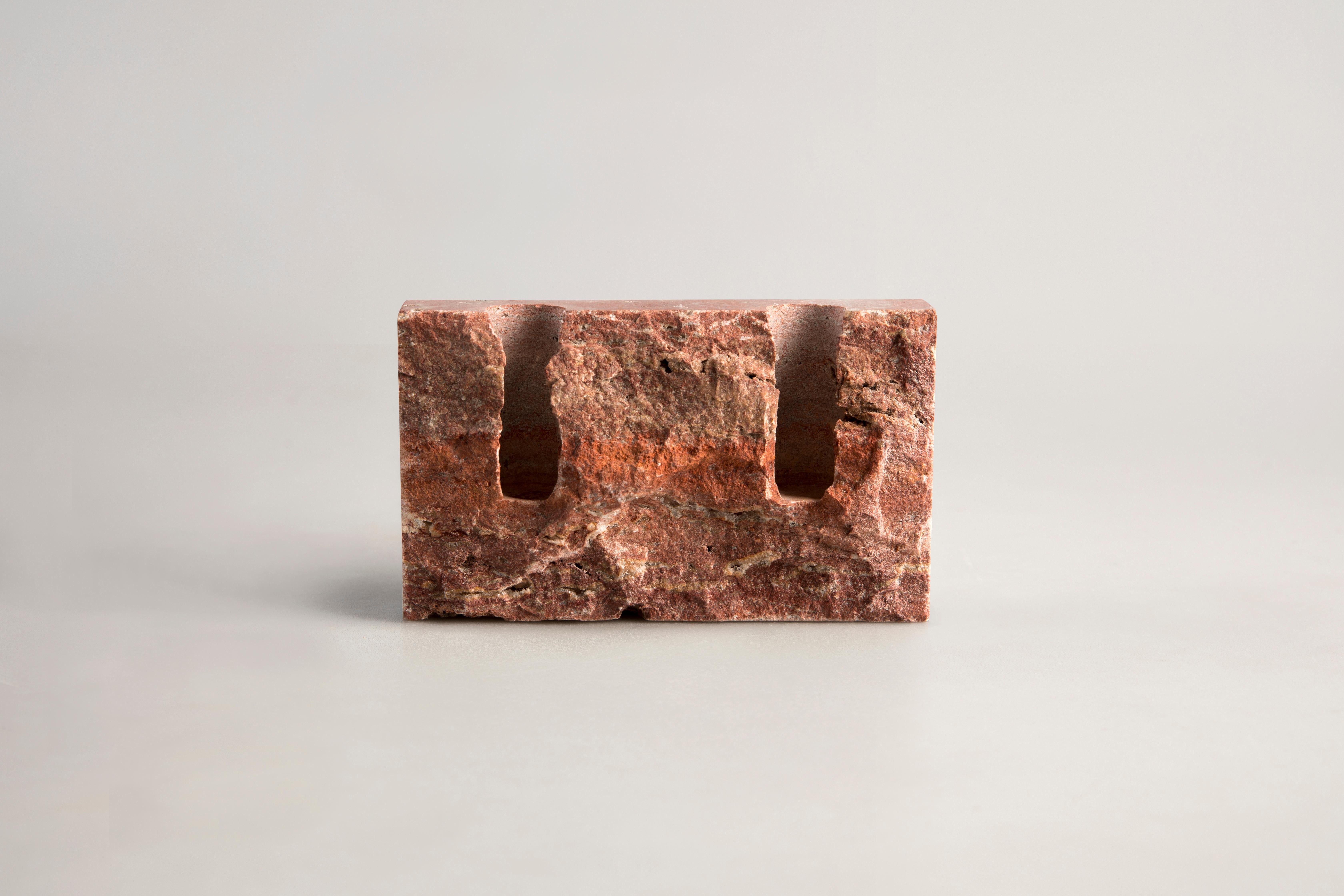 Red Travertine sculpted candleholder by Sanna Völker
The size of the candleholder is 15 x 3 x 9 cm, designed to be used with drip-less candles of size Ø22 mm. 

All pieces are handcrafted in natural stone. This results in variations in colour and