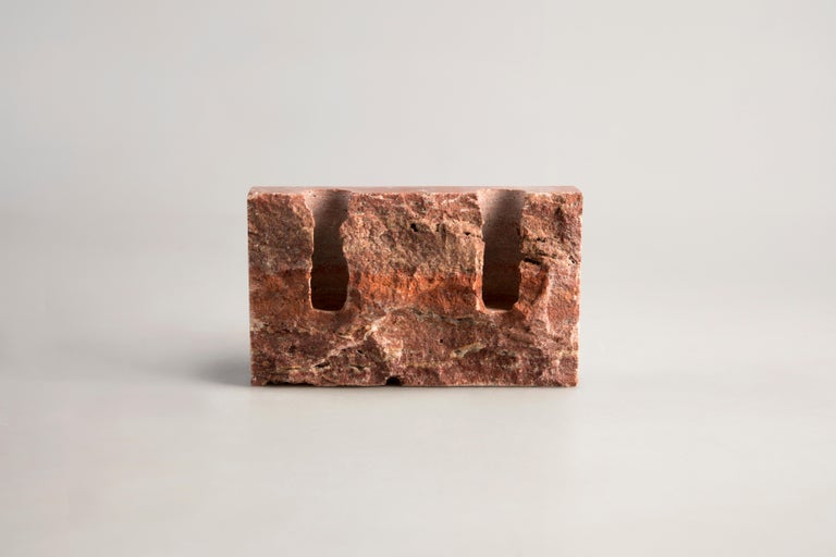 Red Travertine sculpted candleholder by Sanna Völker
The size of the candleholder is 15 x 3 x 9 cm, designed to be used with drip-less candles of size Ø22 mm. 

All pieces are handcrafted in natural stone. This results in variations in color and