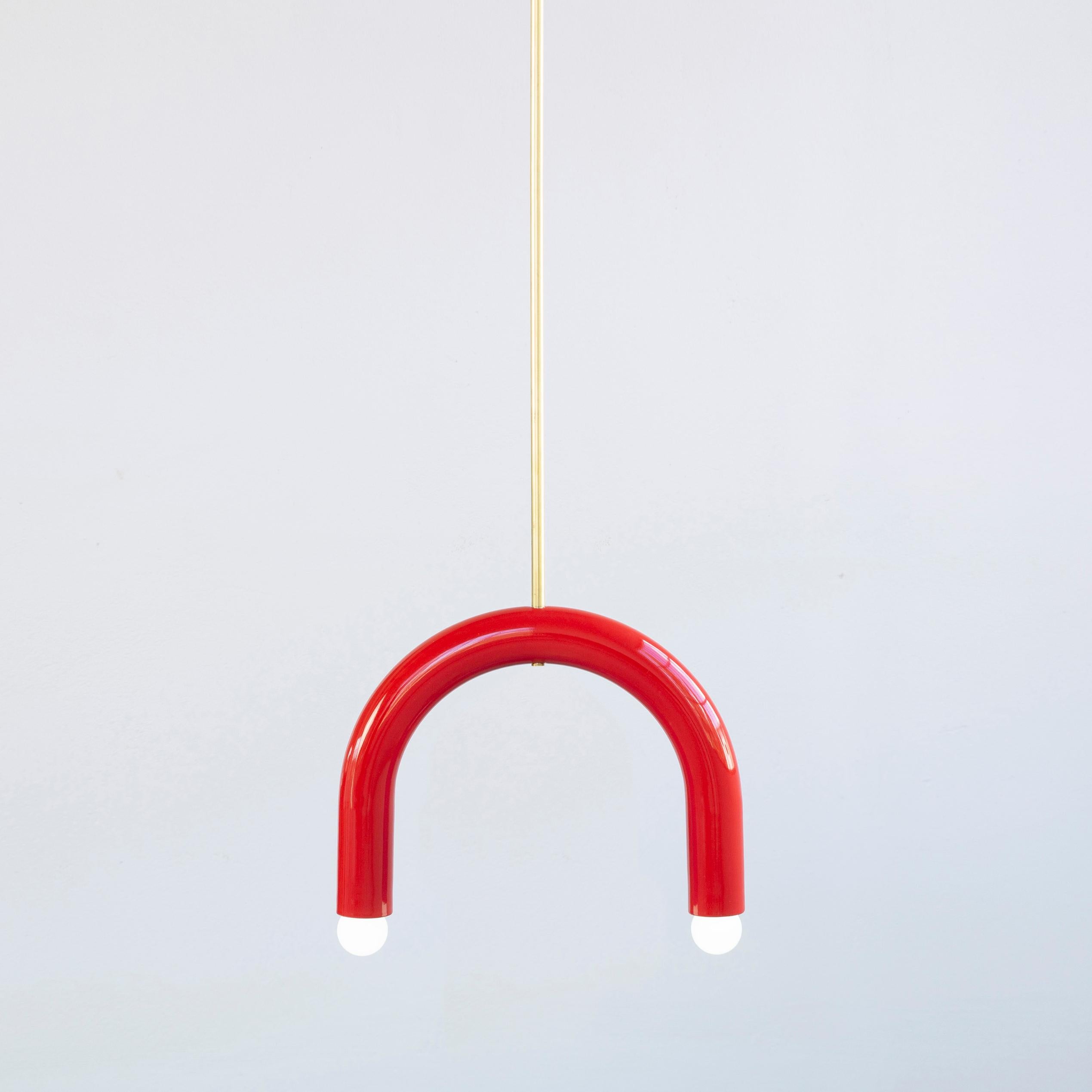 Red TRN B1 pendant lamp by Pani Jurek
Dimensions: D 5 x W 35 x H 28 cm 
Material: Hand glazed ceramic and brass.
Available in other colors.
Lamps from the TRN collection hang on a metal tube, not on a cable. This allows the lamp to be mounted in a