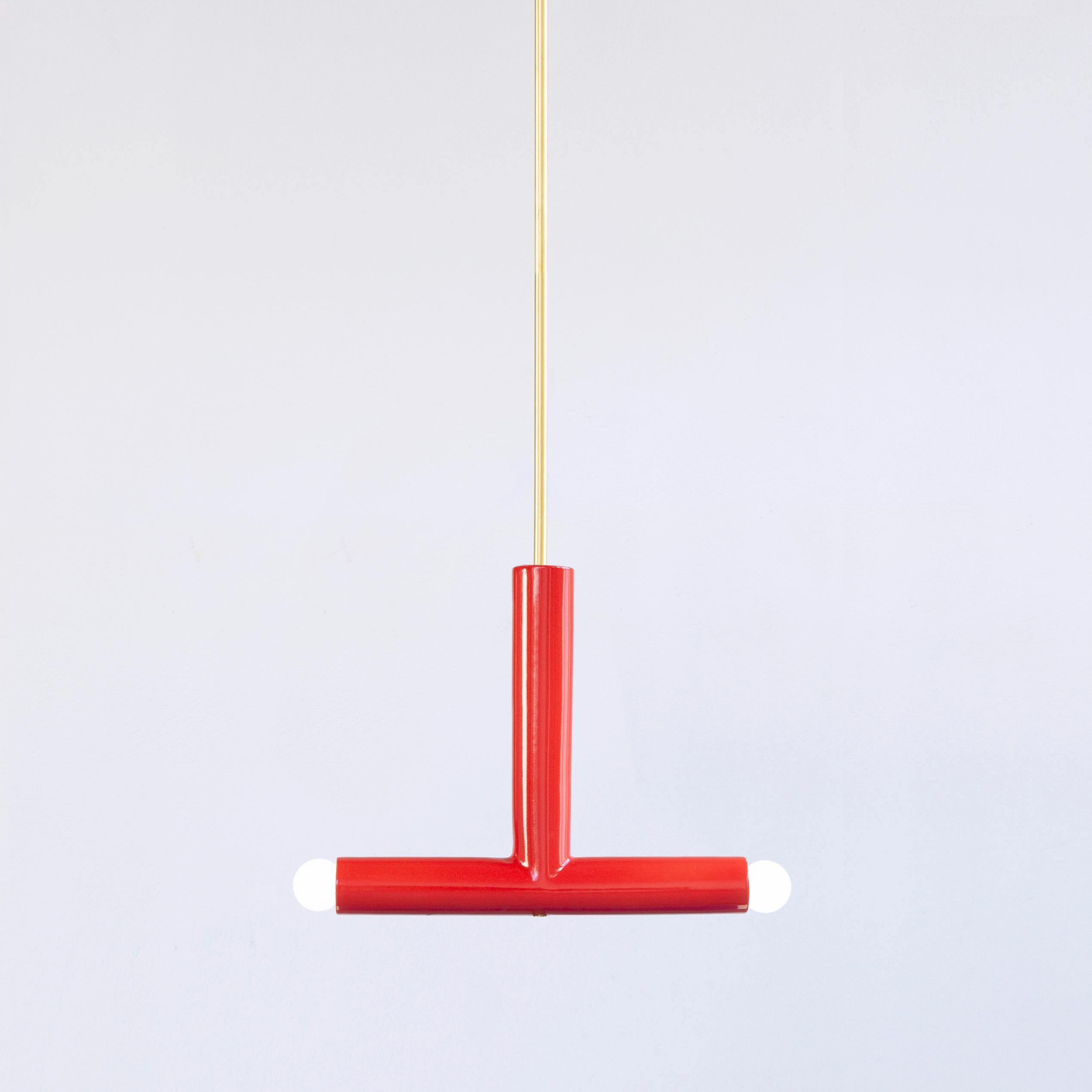 Red TRN B2 pendant lamp by Pani Jurek
Dimensions: D 5 x W 35 x H 30 cm 
Material: Hand glazed ceramic and brass.
Available in other colors.
Lamps from the TRN collection hang on a metal tube, not on a cable. This allows the lamp to be mounted in a