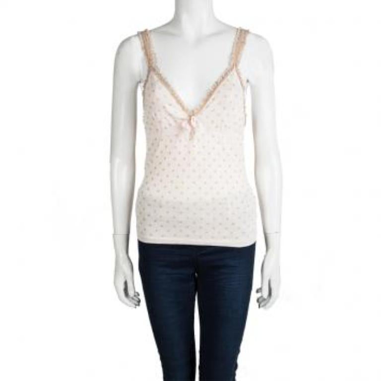 How cute and adorable does this top and cropped cardigan set from Red Valentino look! The lovely baby pink knit set is made of a cotton blend and features a polka dot pattern all over it. The sleeveless top flaunts a deep V-neckline while the