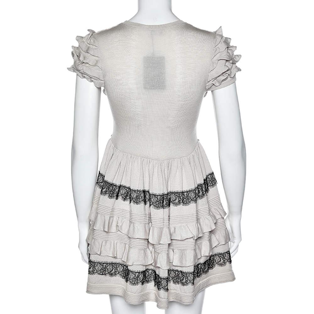 Intricately tailored to perfection, this mini dress from the House of RED Valentino will add a touch of finesse to your appearance. It is stitched using beige wool, which is enriched by contrast lace trims and ruffled detailing. Embrace a stylish