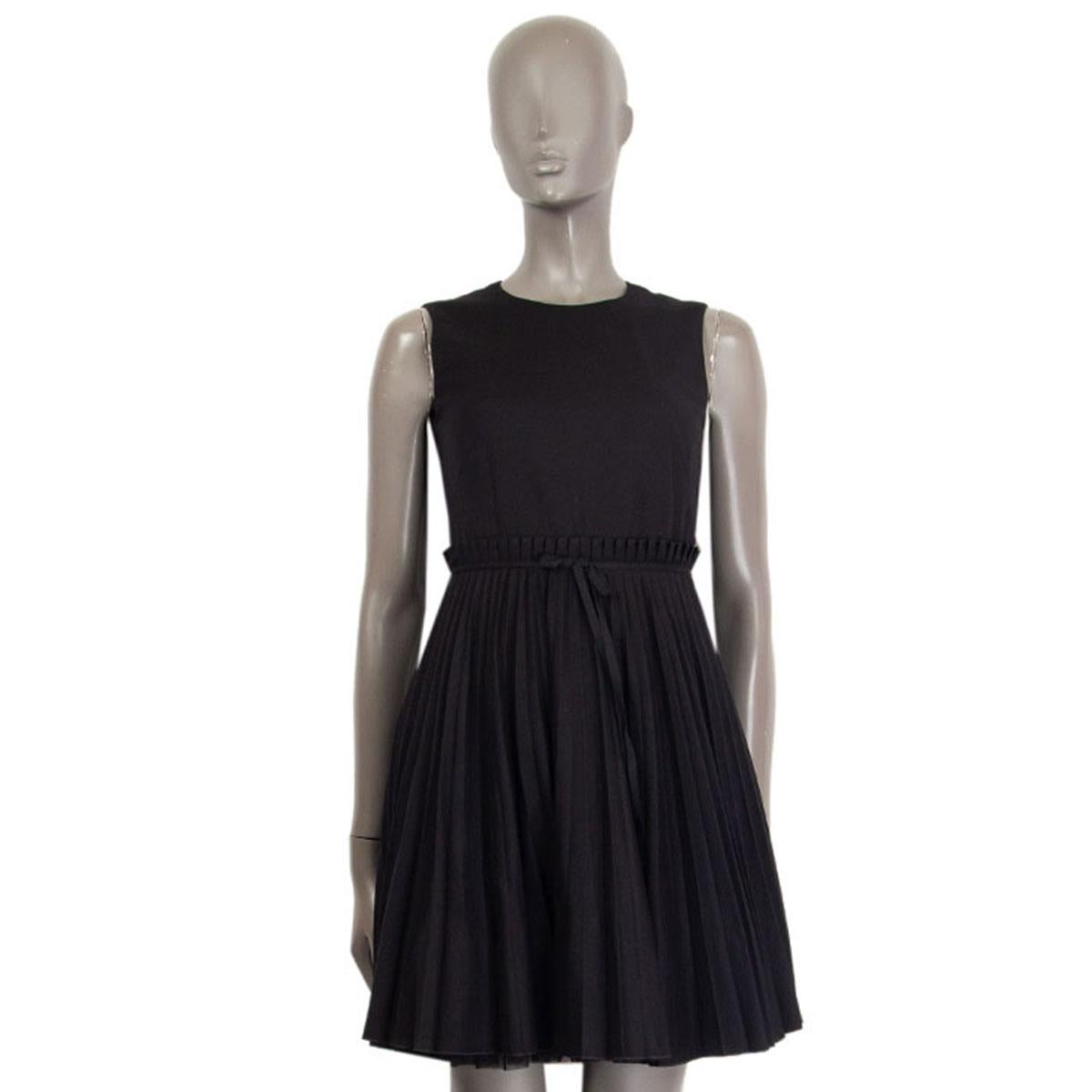 100% authentic R.E.D by Valentino sleeveless dress in black cotton (48%), viscose (30%), virgin wool (20%) and elastane (2%)  with plissé flared skirt and tulle underskirt and round neck-line. Closes with a concealed zipper on the back and has a bow