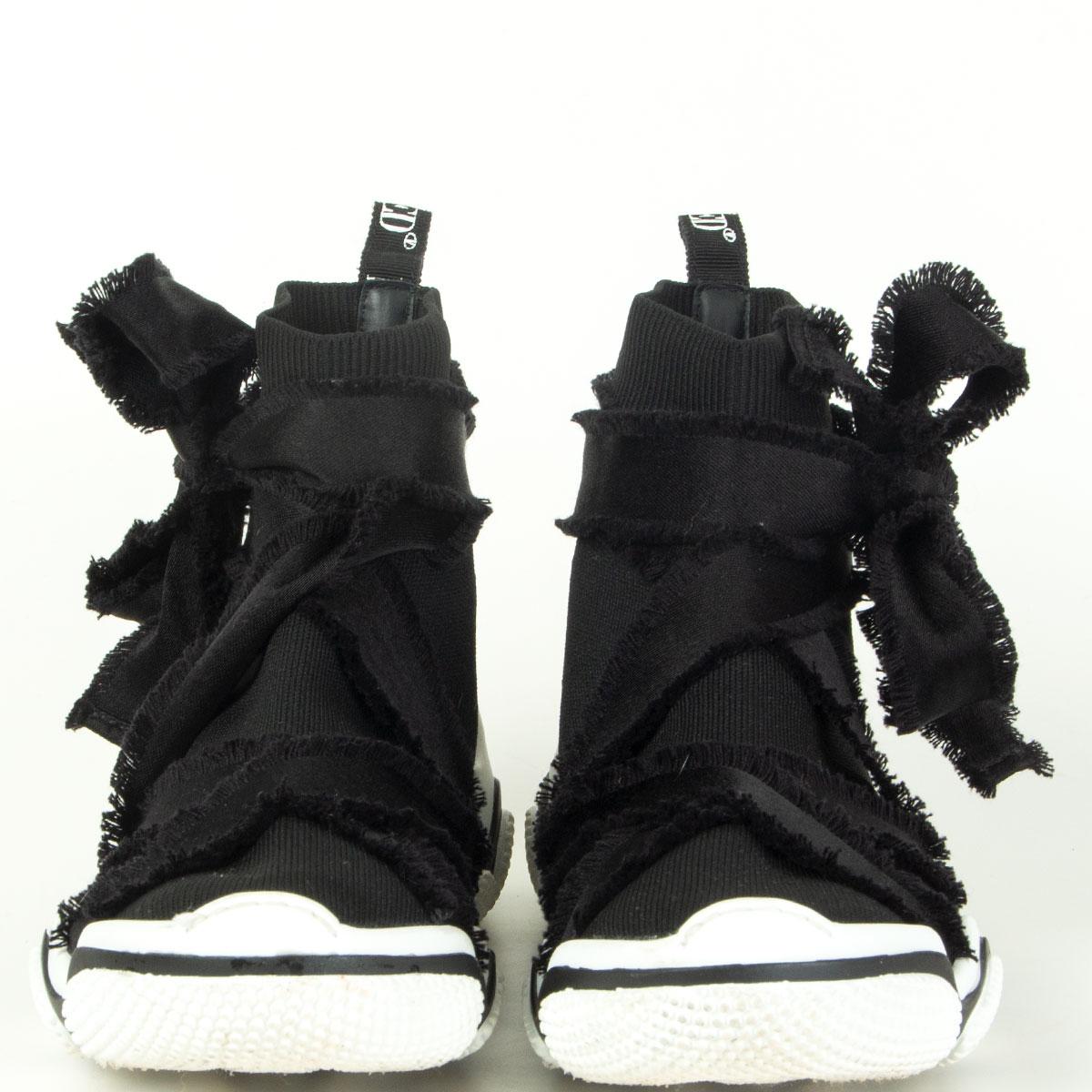 RED by Valentino sock sneakers in black fabric wrapped in straps with fringed edges that tie around the ankles. Black and white rubber sole. Have been worn once or twice and are in excellent condition. 

Imprinted Size 38
Shoe Size 38
Inside Sole