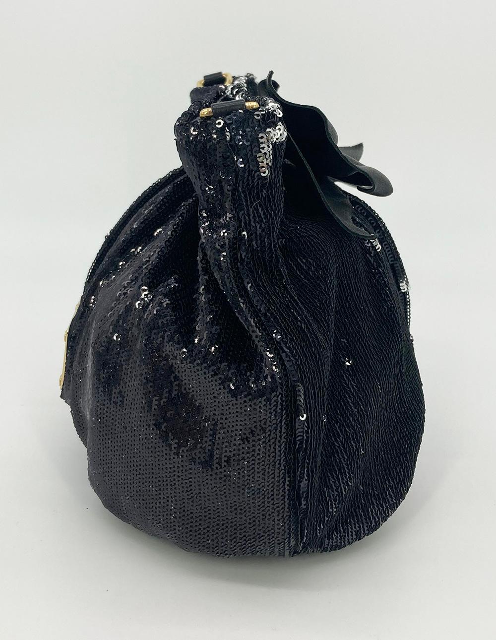 RED Valentino Black Sequin Leather Bow Clutch in excellent condition. Double sided sequin body which changes between black and silver depending on how it's worn, touched or styled. Black leather bow front accent and black leather base. Top magnetic