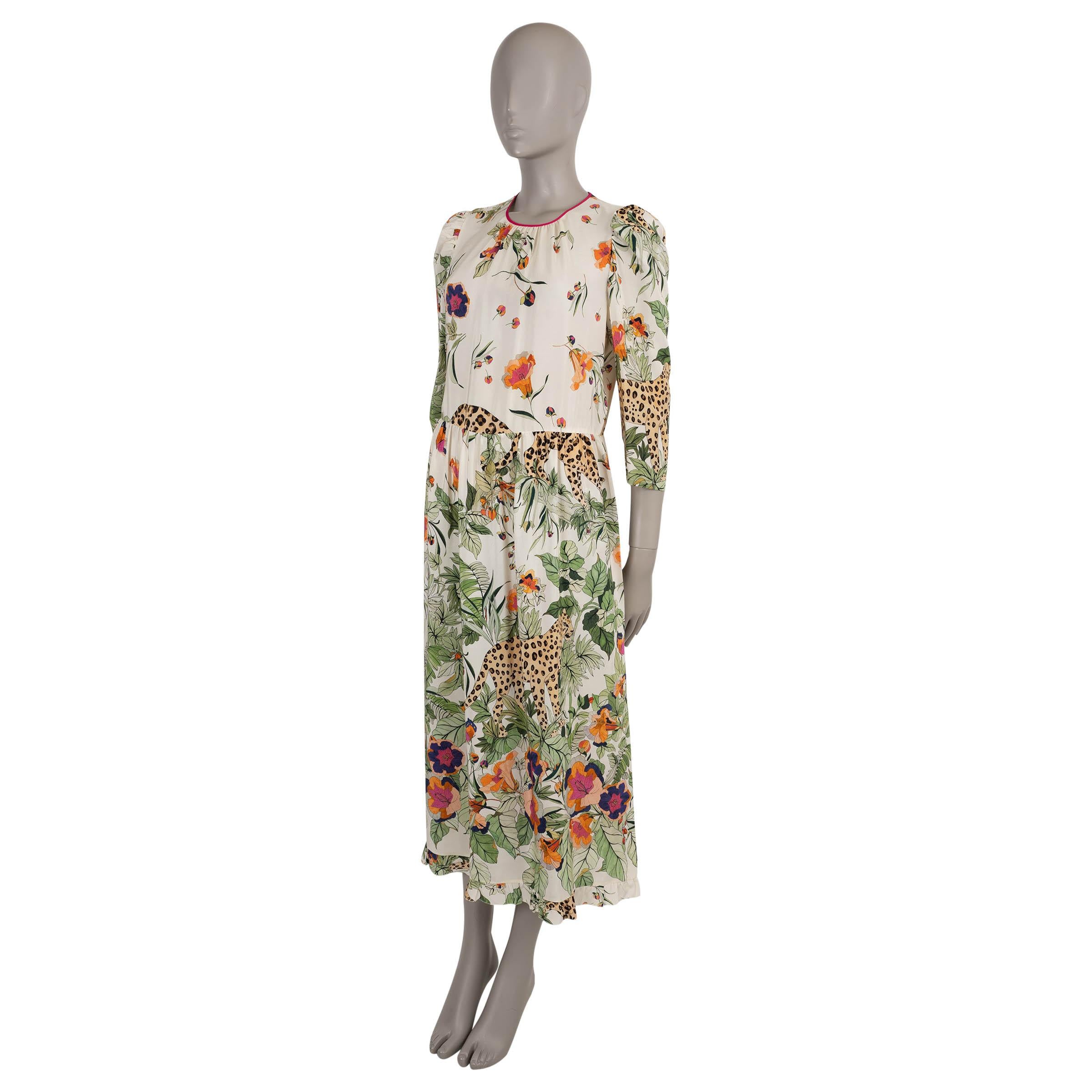 This 100% authentic RED Valentino dress is crafted in white crepe de chine silk with a vibrant multicolor Jungle print. It features a relaxed yet feminine silhouette with a gathered midi-length skirt, round neckline, and 3/4 puff sleeves with zipped