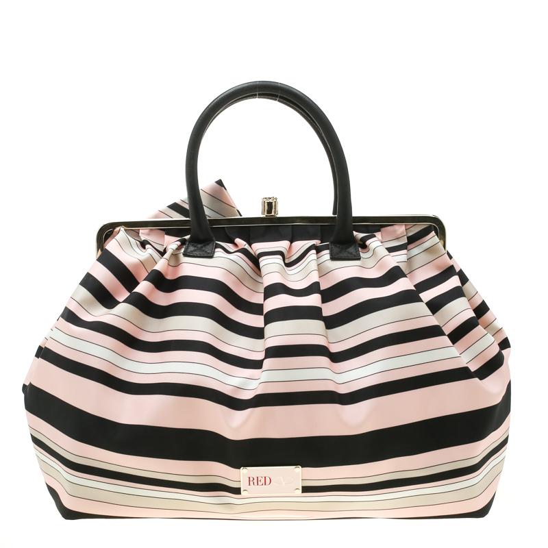 This RED Valentino bag is a must-have! It is expertly designed from striped fabric and gold-tone hardware to form the frame top. The bag features a spacious canvas interior, two leather handles and a large bow detailed on the front.

Includes: Price