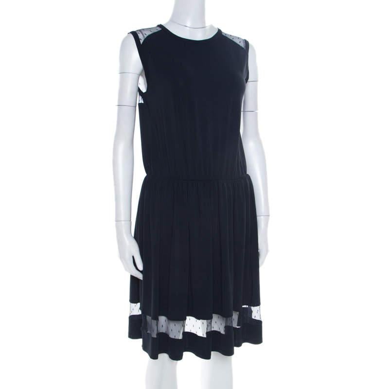 Elegant and graceful, this RED Valentino dress is a true example of the brand's tasteful designs. The navy blue sleeveless creation is made of a blend of fabrics and features a pleated bottom silhouette. It flaunts a sheer lace panel detailing on