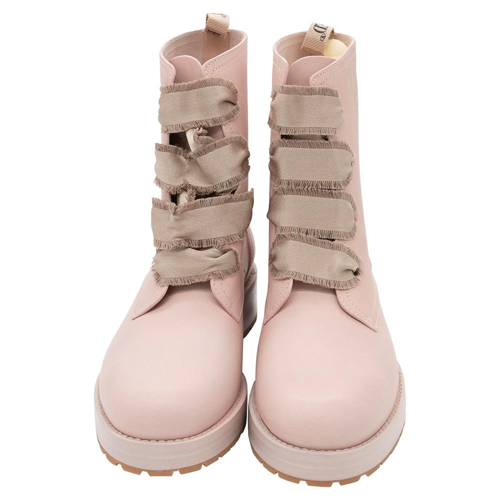 Make a statement everywhere you go by donning these stunning boots by RED Valentino. Crafted in a feminine style, they are made of quality leather with fringed straps detailing on the vamps. These Comballet combat boots are finished with round toes