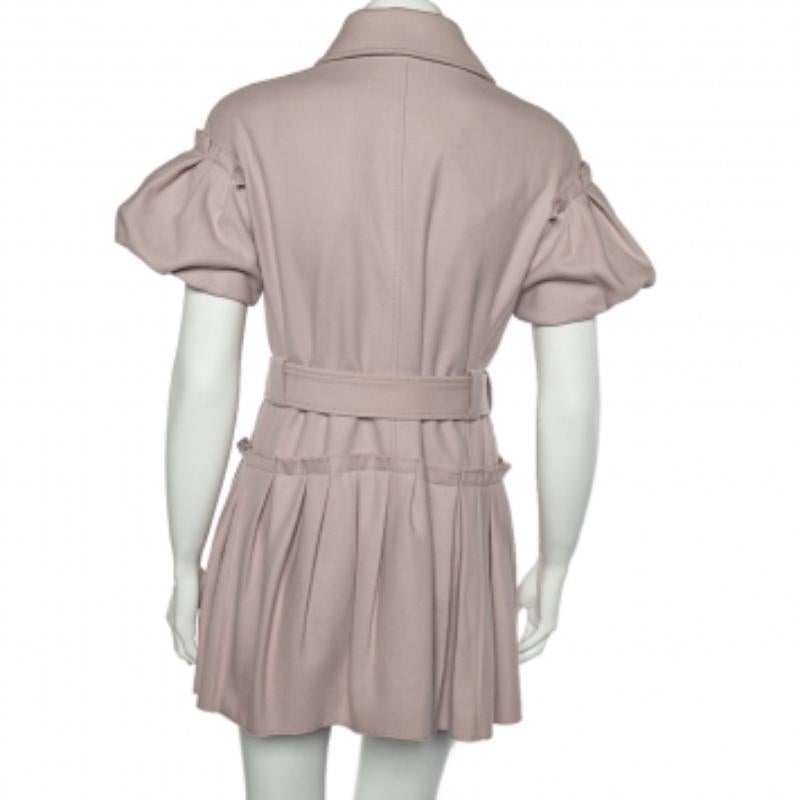 This coat from RED Valentino is a worthy investment. This piece is curated specially to offer style and comfort with its elegant design. It is stitched using pink wool in a double-breasted style with pleated details, a belt, and button accents. This